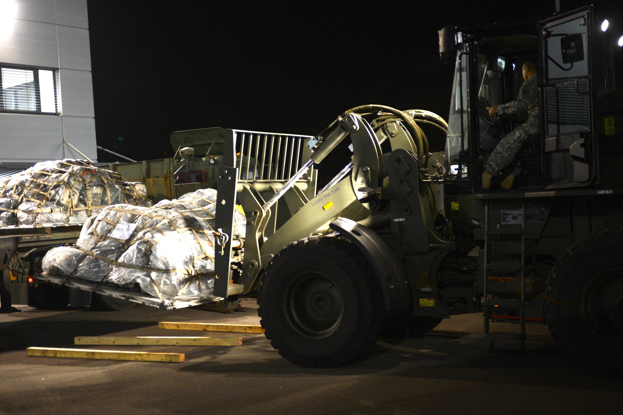 U.S. Army Staff Sgt. Pablo Coffie, 627th Movement Control Team forklift operator, transports pallets of equipment on Ramstein Air Base, Germany, Jan. 9, 2013. The 10th Army Air and Missile Defense Command forces will support the NATO led coalition that will augment Turkey’s air defense capabilities and contribute to the de-escalation of the crisis along the border. (U.S. Air Force photo/Senior Airman Caitlin O’Neil-McKeown)
