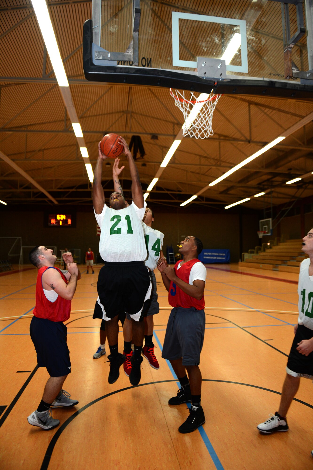 SPANGDAHLEM AIR BASE, Germany – Aramis Williams, 52nd Civil Engineer Squadron, rebounds the ball during a basketball game against the 52nd Communications Squadron inside the Skelton Memorial Fitness Center Jan. 8, 2013. Playoffs for intramural basketball will begin in February. (U.S. Air Force photo by Airman 1st Class Gustavo Castillo/Released)