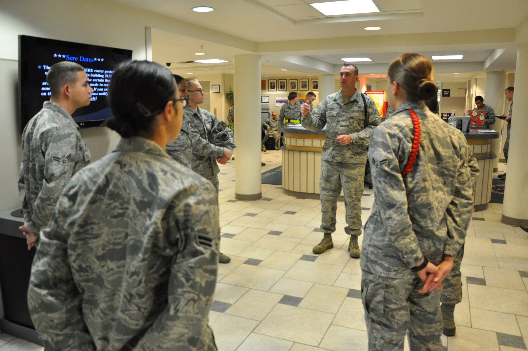 GOODFELLOW AIR FORCE BASE, Texas – Staff Sgt. Barak Heaney, 316th Training Squadron military training instructor, mentors a group of Airmen at Building 3139 here Dec. 20. Heaney informed the Airmen about what they needed to accomplish to out process. (U.S. Air Force photo/ Airman 1st Class Joshua Edwards)