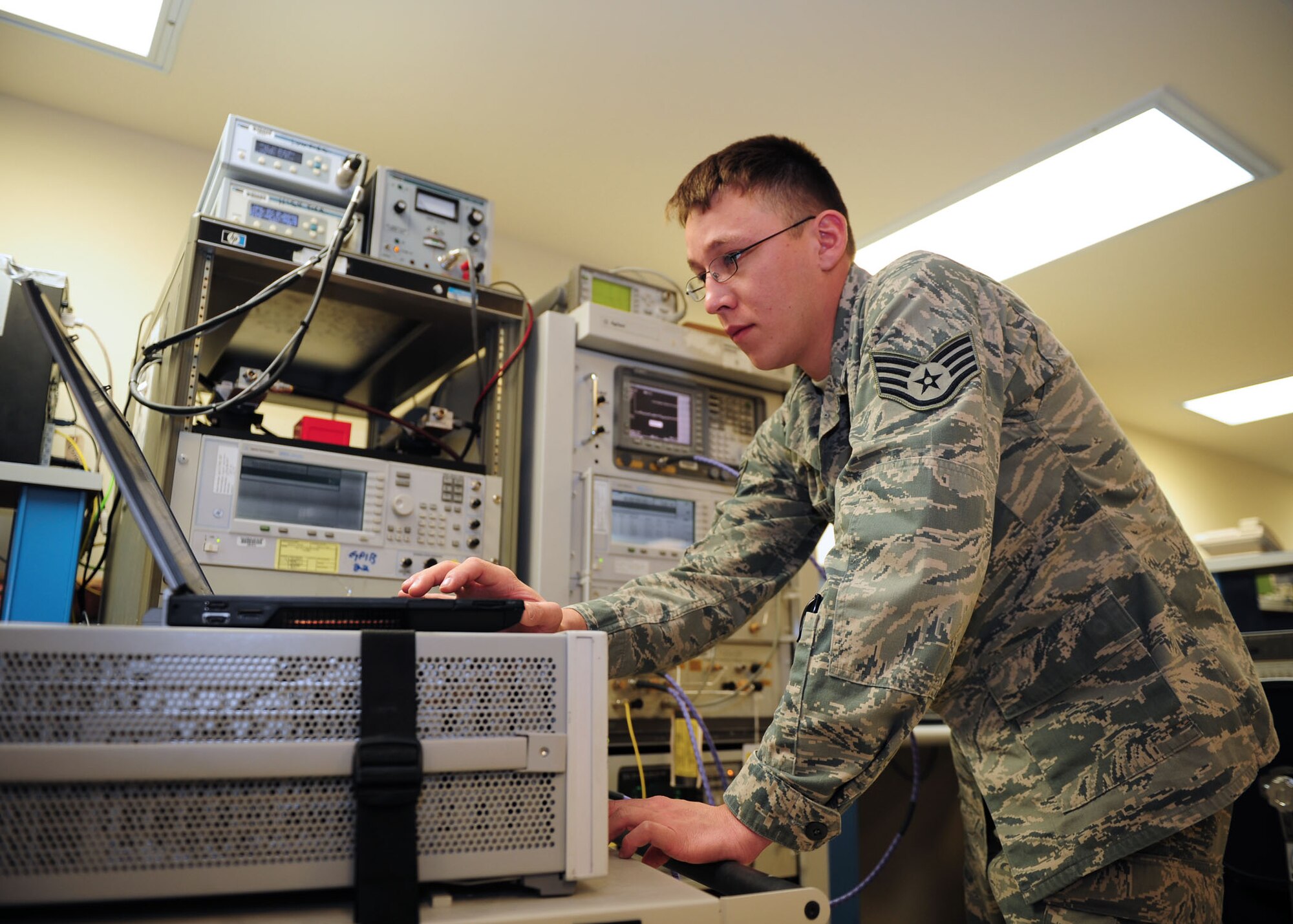 SOUTHWEST ASIA -- Staff Sgt. Jared Hahn, 379th Expeditionary Maintenance Squadron Test, Measurement and Diagnostic Equipment unit, checks for 'signal bleed' with a phase noise system. The test helps insure a clean signal, free from possible distortions. The TMDE unit provides timely and precise calibration of equipment in the area of responsibility. It supports more than 290 work centers and 19 bases in 10 countries throughout the AOR. (U.S. Air Force photo/Master Sgt. Brendan Kavanaugh)