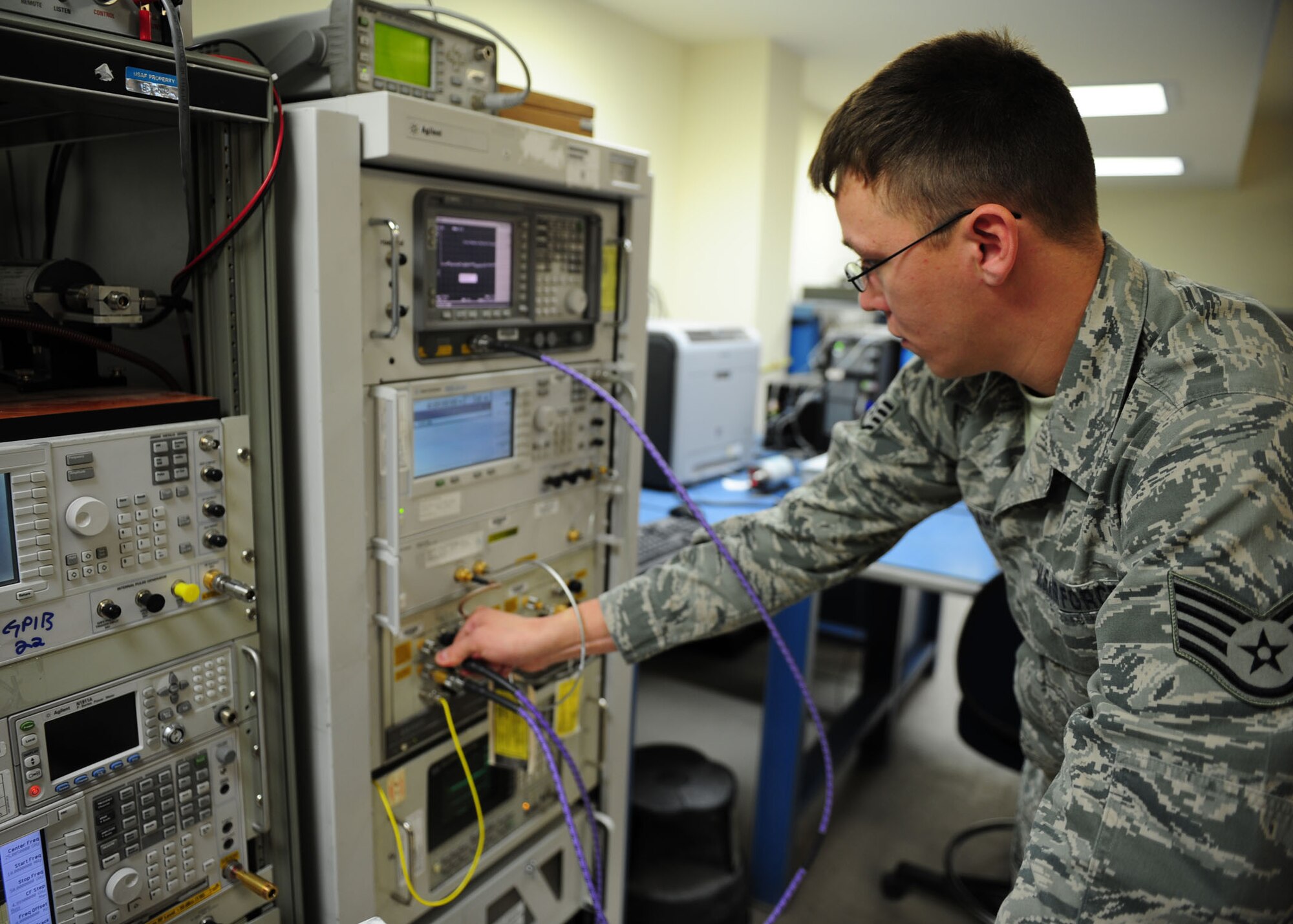 SOUTHWEST ASIA -- Staff Sgt. Jared Hahn, 379th Expeditionary Maintenance Squadron Test, Measurement and Diagnostic Equipment unit, checks for 'signal bleed' with a phase noise system. The test helps insure a clean signal, free from possible distortions. The TMDE unit provides timely and precise calibration of equipment in the area of responsibility. It supports more than 290 work centers and 19 bases in 10 countries throughout the AOR. (U.S. Air Force photo/Master Sgt. Brendan Kavanaugh)