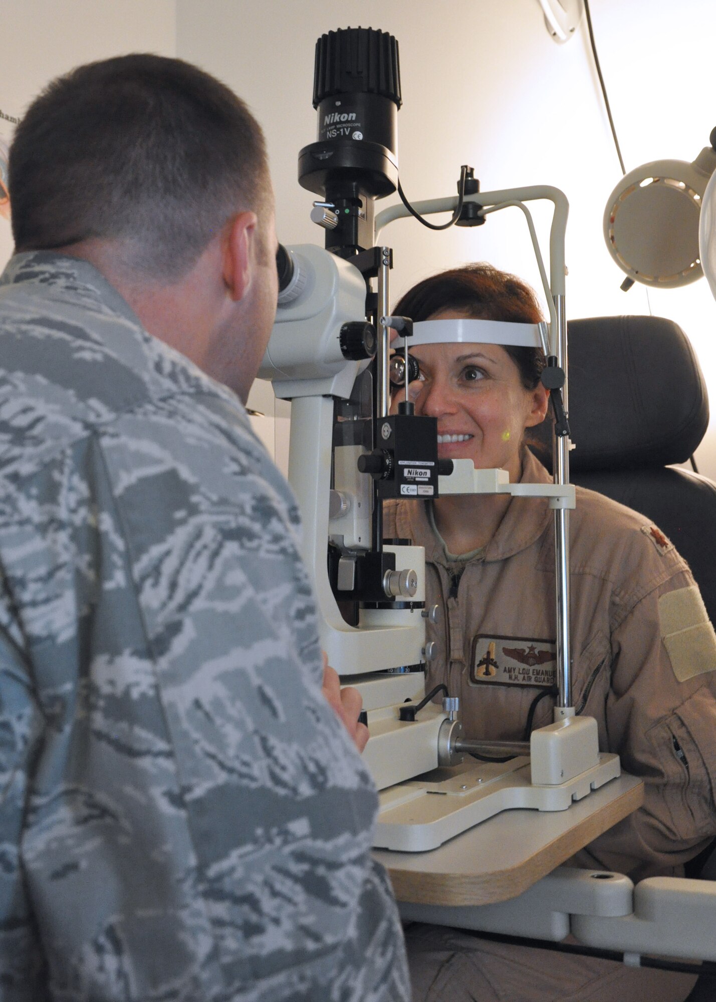 Optometrist Capt. Mike Gitchel inspects the retina of pilot Maj. Amy Lou Emanuel, 340th Expeditionary Refueling Squadron, January 6, 2013. The 379th Expeditionary Aeromedical-Dental Flight optometry element is a full-service clinic available to U.S. and coalition service members, government civilians and base contractors supporting operations in Southwest Asia. (U.S. Air Force photo/Master Sgt. Christian Michael)