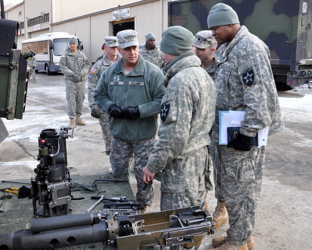 Maj. Gen. Kendall Cox, U.S. Army Corps of Engineers deputy commander for military and international operations, speaks with a soldier from the 1st Brigade Special Troops Battalion, 2nd Infantry Division, at Camp Hovey, Republic of Korea, Jan. 8.  Cox talked to the Soldier, who was reassembling a 25mm chain gun for an M2A3 Bradley Fighting Vehicle, during his visit to the base, north of Seoul, where he met with the division’s combat engineers, commonly known as “sappers.”   Cox was in Korea for a three-day visit, meeting with U.S. military leadership and on the peninsula and visiting the Corps of Engineers Far East District construction projects at U.S. Army Garrison Humphreys.  