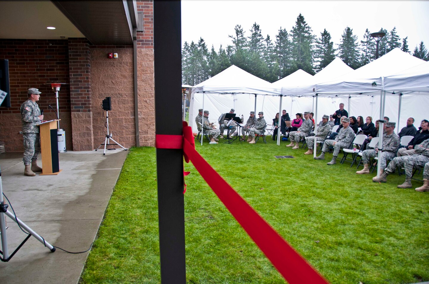 Col. Dallas Homas, Madigan Healthcare System commander, address the crowd of people who attended the Installation Management Command's ribbon cutting ceremony for the Soldier and Family Assistance Center and Open House for the Warrior Transistion Battalion Headquarters held Jan. 7 at Joint Base Lewis McChord.  The building was a U.S. Army Corps of Engineers, Seattle District, military construction project and was built by Doyon Government Group. 