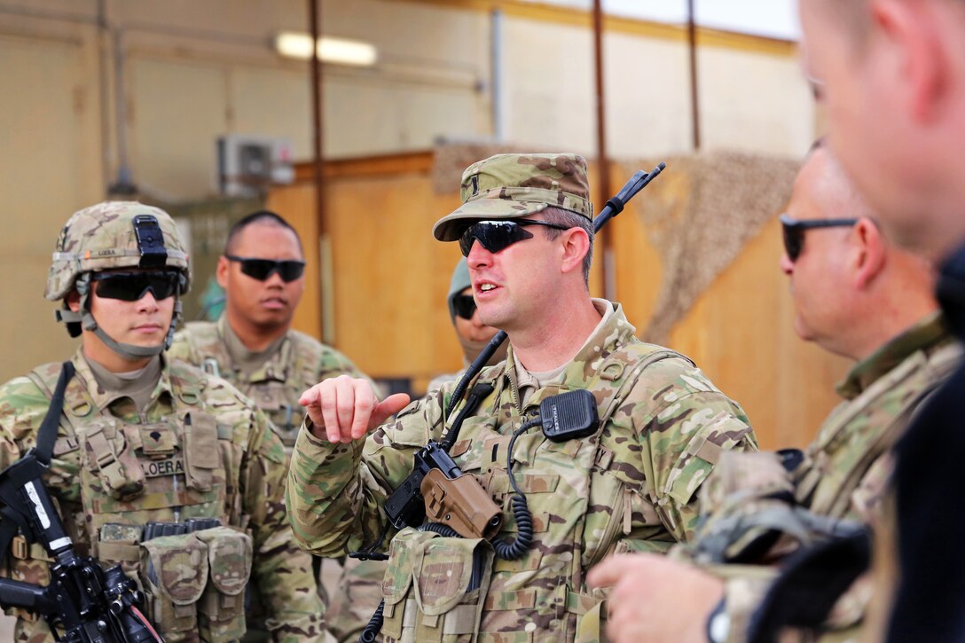 U.S. Army 1st Lt. Ryan Schulte, center, debriefs upon returning to Forward Operating Base Farah after a leadership meeting in Farah City, Afghanistan, Jan. 8, 2013. Schulte is assigned to Provincial Reconstruction Team Farah.