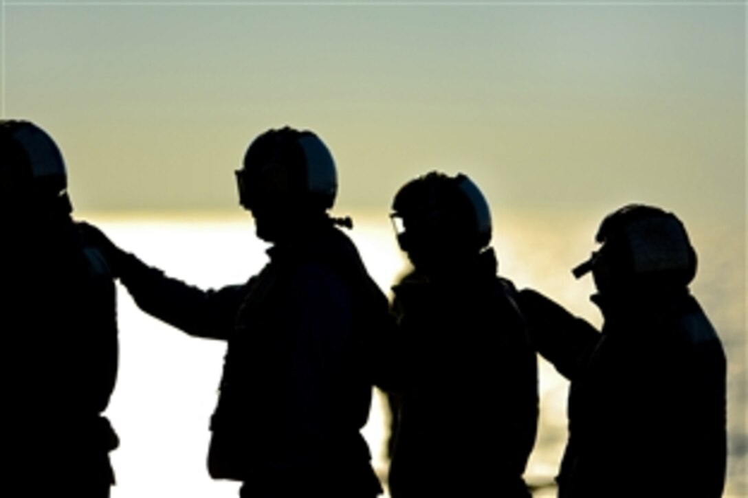 U.S. sailors line up during a fire fighting exercise on the flight deck aboard the aircraft carrier USS George H.W. Bush in the Atlantic Ocean, Jan. 7, 2013. The Bush is conducting training and carrier qualifications. 