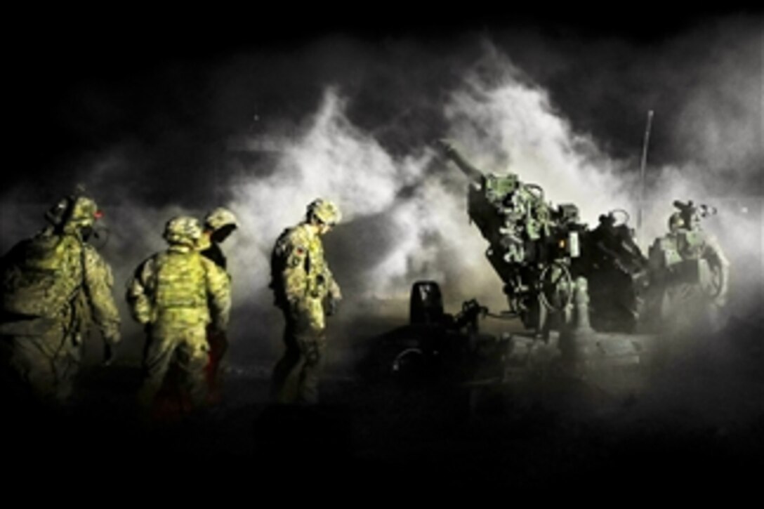 A U.S. Army gun crew uses a M777 A2 howitzer to fire illumination rounds from Forward Operating Base Hadrian in the Deh Rawud district of Afghanistan on Jan. 8, 2013.  The crew from 1st Section Bravo Battery 1-9 Field Artillery of Fort Stewart, Ga., has been conducting intensive training and fire missions to support operations in Uruzgan province.  