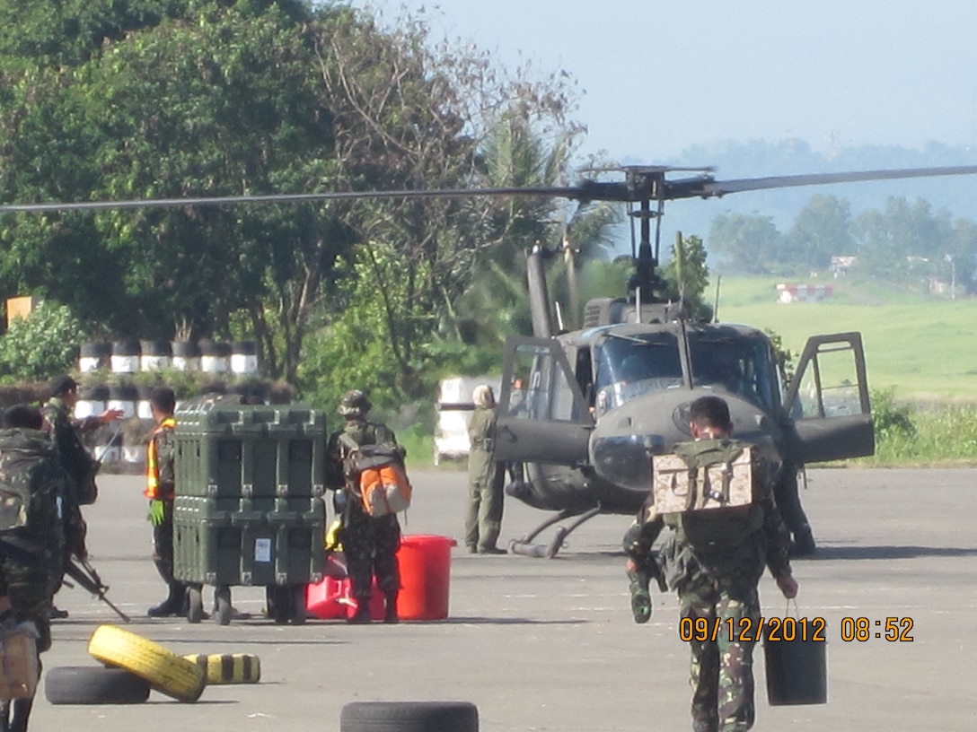 Members of the Armed Forces of the Philippines deploy an Aspen 2000 water purification system to Baganga Dec. 9 in order to provide relief to local communities affected by Typhoon Bopha. The U.S. Marine Corps Forces, Pacific Experimentation Center was able to gather operational feedback by lending these systems to communities in need of potable water. 