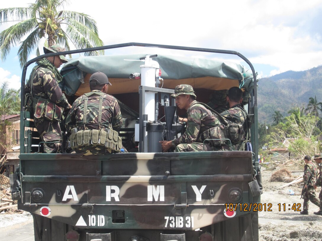 Armed Forces of the Philippines soldiers and U.S. Marine Corps Forces, Pacific Experimentation Center staff search for a water source in order to set up the First Response water purification system here Dec. 10. The MEC was able to gather operational feedback while providing relief to communities struck by Typhoon Bopha. 