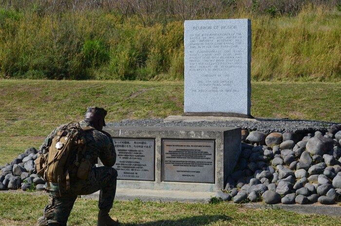 Master Gunnery Sergeant Johnnie L. Jackson pays tribute on Iwo To, Japan, formerly known as Iwo Jima during a profession military education visit here Dec. 19. Members of the 3rd Marine Logistics Group, III Marine Expeditionary Force, including Jackson, visited the island to show respect for those who lost their lives during the World War II Battle of Iwo Jima and to gain a better understanding of what Marines who fought here experienced.