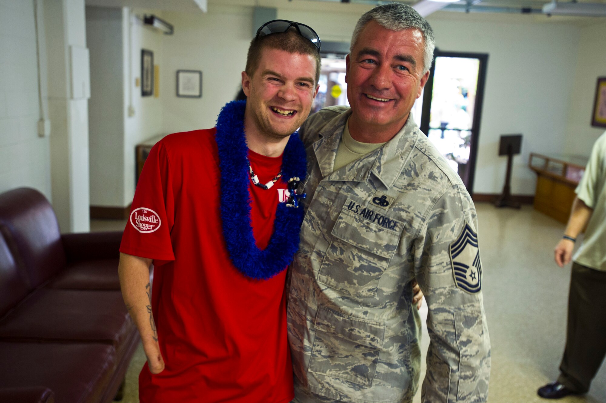 Chief Master Sgt. Chuck Willis of the Pacific Air Forces Inspector General team and Kyle Earl of the Wounded Warrior Amputee Softball Team share a laugh during the softball team's visit to Hickam field Jan. 10. The WWAST mission is to raise awareness, through exhibition and celebrity softball games, of the sacrifices and resilience of the U.S. Military. (U.S. Air Force photo by Staff Sgt. Nathan Allen)