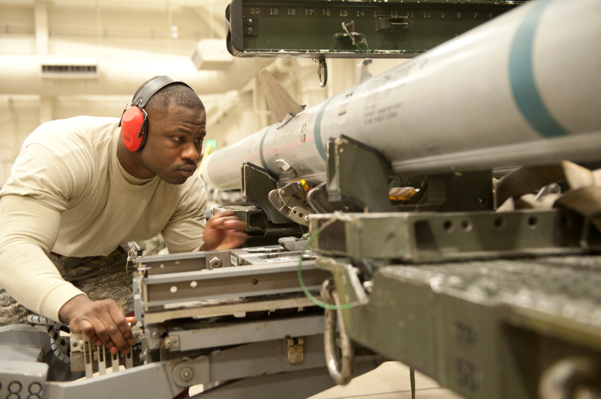 Air Force Staff Sgt. Vincent Sweet prepares an AIM-120 Advanced Medium Range Air-to-Air Missile to be loaded onto an F-22 Raptor during a weapons load competition Jan. 4. Sweet is a weapons load crew chief with the 90th Aircraft Maintenance Unit. The weapons load competitions test the units??? abilities and help them improve in the safety of a training environment. Sweet hails from Dalhart, Texas. (U.S. Air Force photo/Staff Sgt. Robert Barnett)