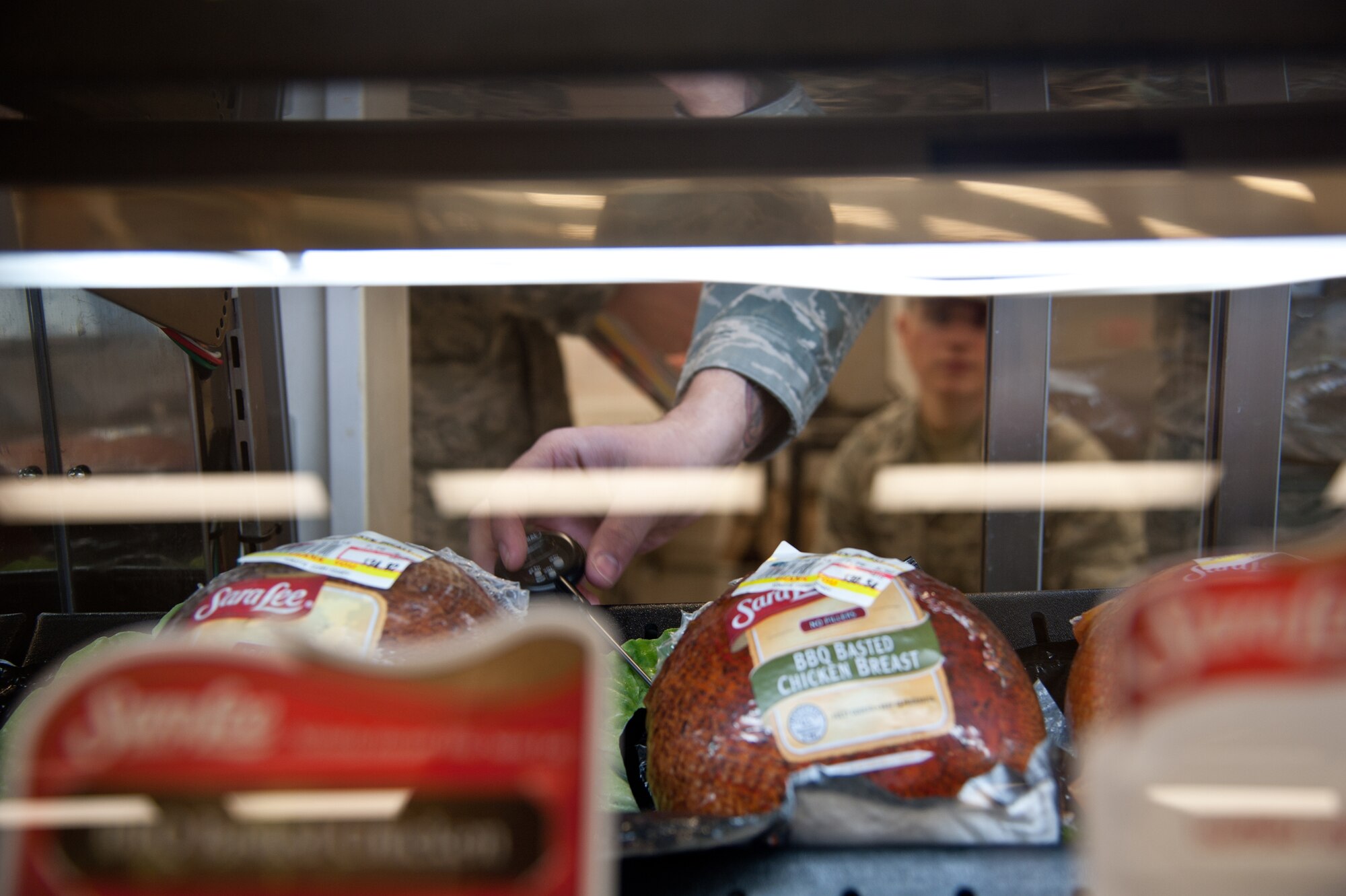 YOKOTA AIR BASE, Japan -- A team of 374th Aerospace Medicine Squadron Public Health food and sanitation Airmen check the temperature of deli meat for sale at the Yokota Commissary Jan. 8, 2013. Public Health ensures the food products available to the Yokota community are handled with care and those handling them follow a strict health code. (U.S. Air Force photo Senior Airman Cody H. Ramirez)