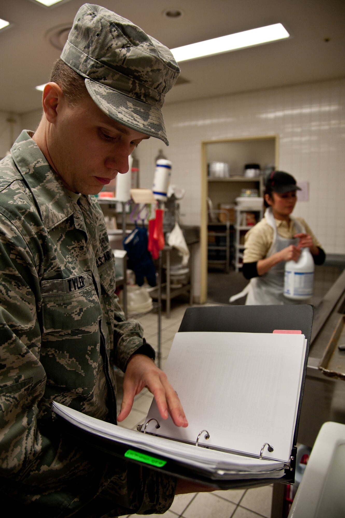 YOKOTA AIR BASE, Japan -- Senior Airman Roland Tyler, 374th Aerospace Medicine Squadron Public Health food and sanitation journeyman, reviews a checklist Jan. 8, 2013, while inspecting the Yokota Commissary deli and bakery. Inspections are conducted monthly by Public Health to ensure all facilities on base, especially those serving food, follow strict health regulations. (U.S. Air Force photo by Senior Airman Cody H. Ramirez)
