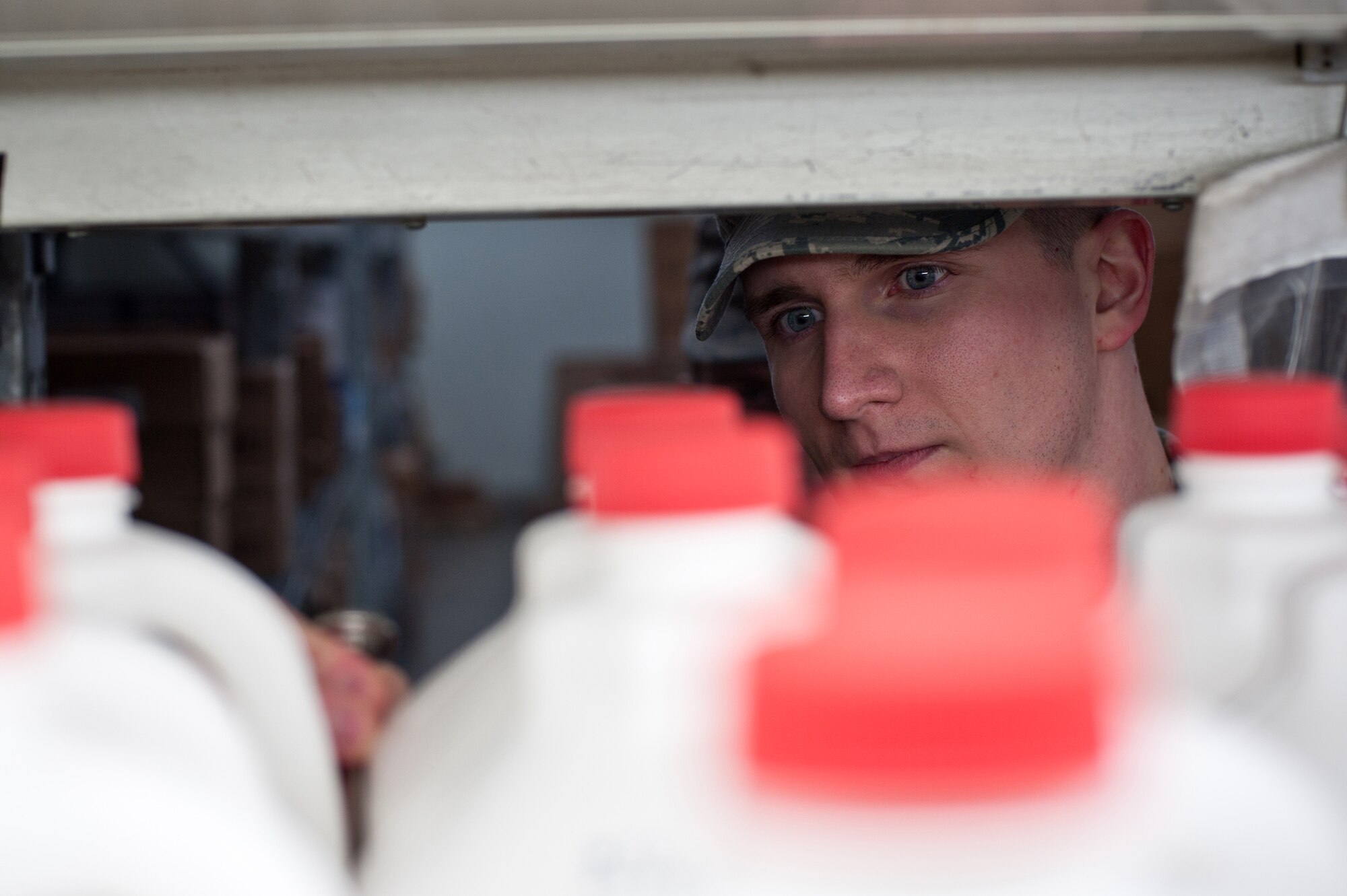 YOKOTA AIR BASE, Japan -- Staff Sgt. Nick Warner, 374th Aerospace Medicine Squadron Public Health NCO in charge of food and sanitation element, measures the temperature of milk and checks their expiration dates Jan. 8, 2013, at the Yokota Commissary to ensure proper storage and removal if necessary. Warner assisted Public Health in conducting 290 inspections during 2012. (U.S. Air Force photo by Senior Airman Cody H. Ramirez)