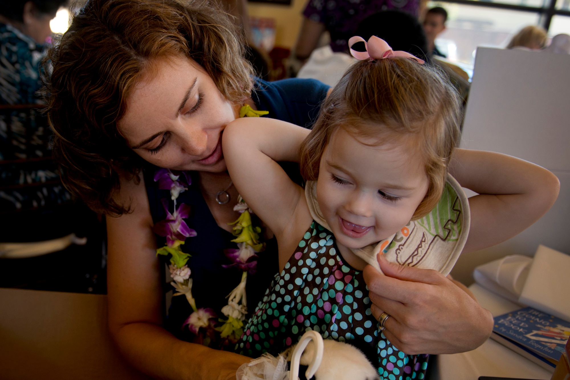 Danica Elliott, wife of a 25th Combat Aviation Brigade Soldier, Schofield Barracks, Hawaii, and daughter Idra, 2, looks at items they picked out of the “Showers in a Box” during Operation Shower, "You Are My Sunshine," Jan. 8 at the Ka Makani Community Center, Joint Base Pearl Harbor-Hickam, Hawaii. The mothers and mothers-to-be being honored has their spouse already deployed or soon to be deployed. Each of the 40 mothers from multiple services on Hawaii received more than $1,000 worth of baby items ranging from gift cards, and diapers to crib bedding and strollers. This is the 28th baby shower held by the nonprofit group and the first in Hawaii.   (U.S. Air Force photo/Staff Sgt. Mike Meares)