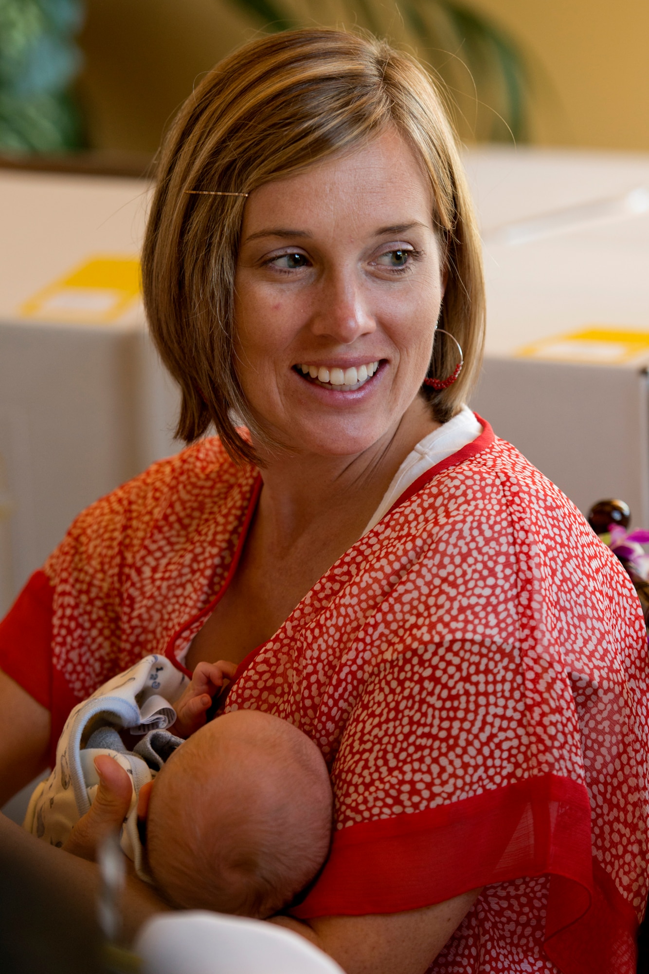 Elizabeth Nixon, wife of U.S. Army Capt. Brandon Nixon, 25th Combat Aviation Brigade, Schofield Barracks, Hawaii, looks at a gift of appreciation during Operation Shower, "You Are My Sunshine," Jan. 8 at the Ka Makani Community Center, Joint Base Pearl Harbor-Hickam, Hawaii. Nixon, who missed the birth of his son by two weeks, is set to return from deployment any day after being gone for almost a year. The mothers and mothers-to-be being honored has their spouse already deployed or soon to be deployed. Each of the 40 mothers from multiple services on Hawaii received more than $1,000 worth of baby items ranging from gift cards, and diapers to crib bedding and strollers. This is the 28th baby shower held by the nonprofit group and the first in Hawaii.   (U.S. Air Force photo/Staff Sgt. Mike Meares)