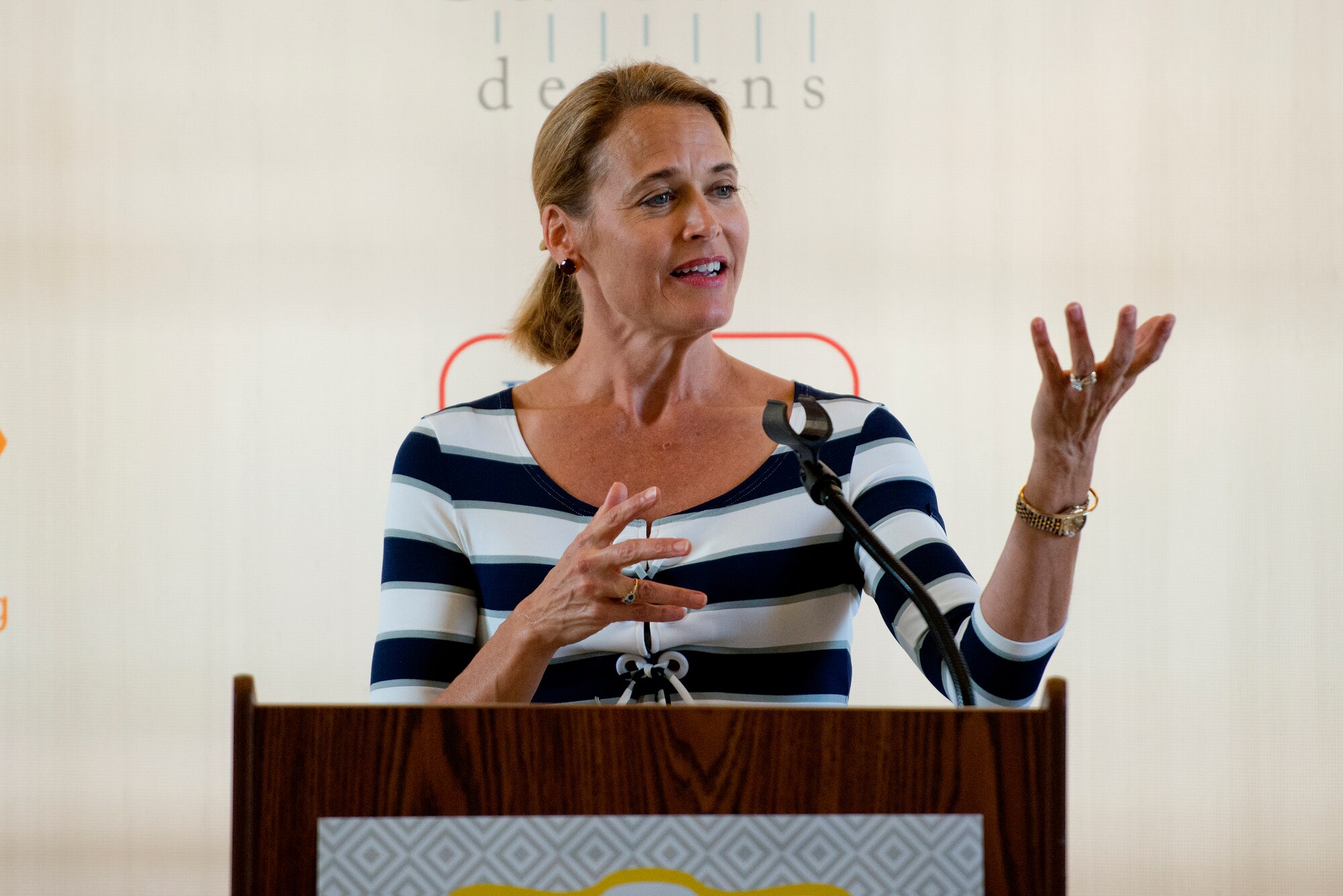 Holly Finchem, wife of PGA Tour commissioner Tim Finchem, speaks to servicemembers and their families during the Operation Shower, "You Are My Sunshine," Jan. 8 at the Ka Makani Community Center, Joint Base Pearl Harbor-Hickam, Hawaii. The mothers and mothers-to-be being honored has their spouse already deployed or soon to be deployed. Each of the 40 mothers from multiple services on Hawaii received more than $1,000 worth of baby items ranging from gift cards, and diapers to crib bedding and strollers. This is the 28th baby shower held by the nonprofit group and the first in Hawaii.   (U.S. Air Force photo/Staff Sgt. Mike Meares)