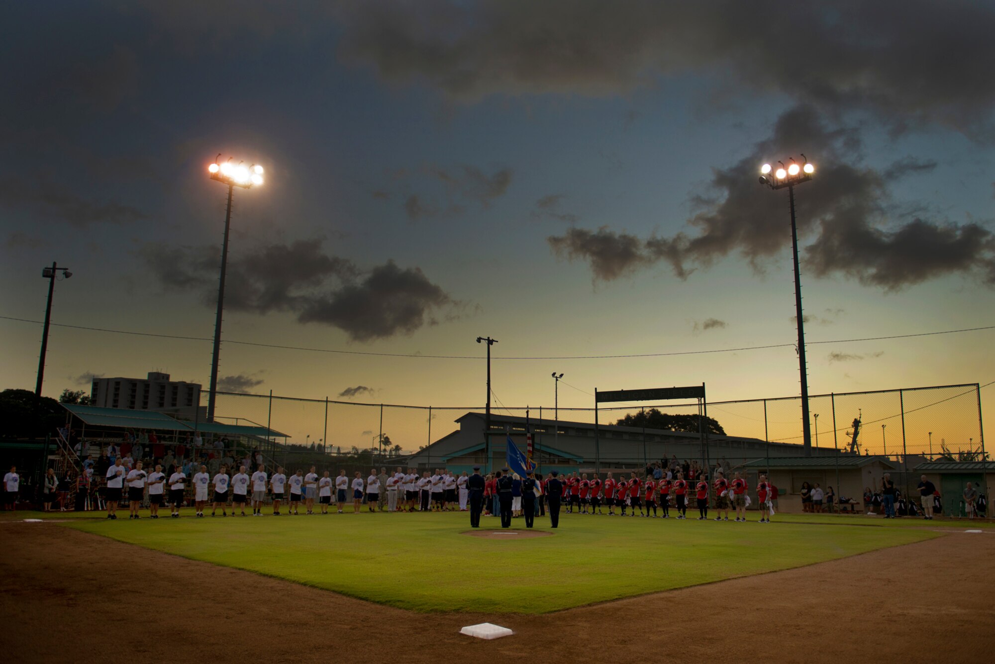 The Hickam Honor Guard presents the colors for the singing of the National Anthem at the beginning of a double header featuring the Wounded Warrior Amputee Softball Team against Hickam Force and Hickam Chiefs, Jan. 8, 2013, at Milican Field, Joint Base Pearl Harbor-Hickam, Hawaii. Hickam Force won the first game 18-1, but the Warriors held off the Chiefs Group to win 22-17. The WWAST is comprised of competitive, athletic veterans and active duty servicemembers who have lost limbs during post-9/11 combat operations. The team includes individuals with a variety of amputations of the arm, above knee, below knee, bilateral below knee, and foot. Some are still in the service, while others are attending college thanks to the Post-9/11 GI Bill while others have moved on to new careers. (U.S. Air Force photo/Staff Sgt. Mike Meares)