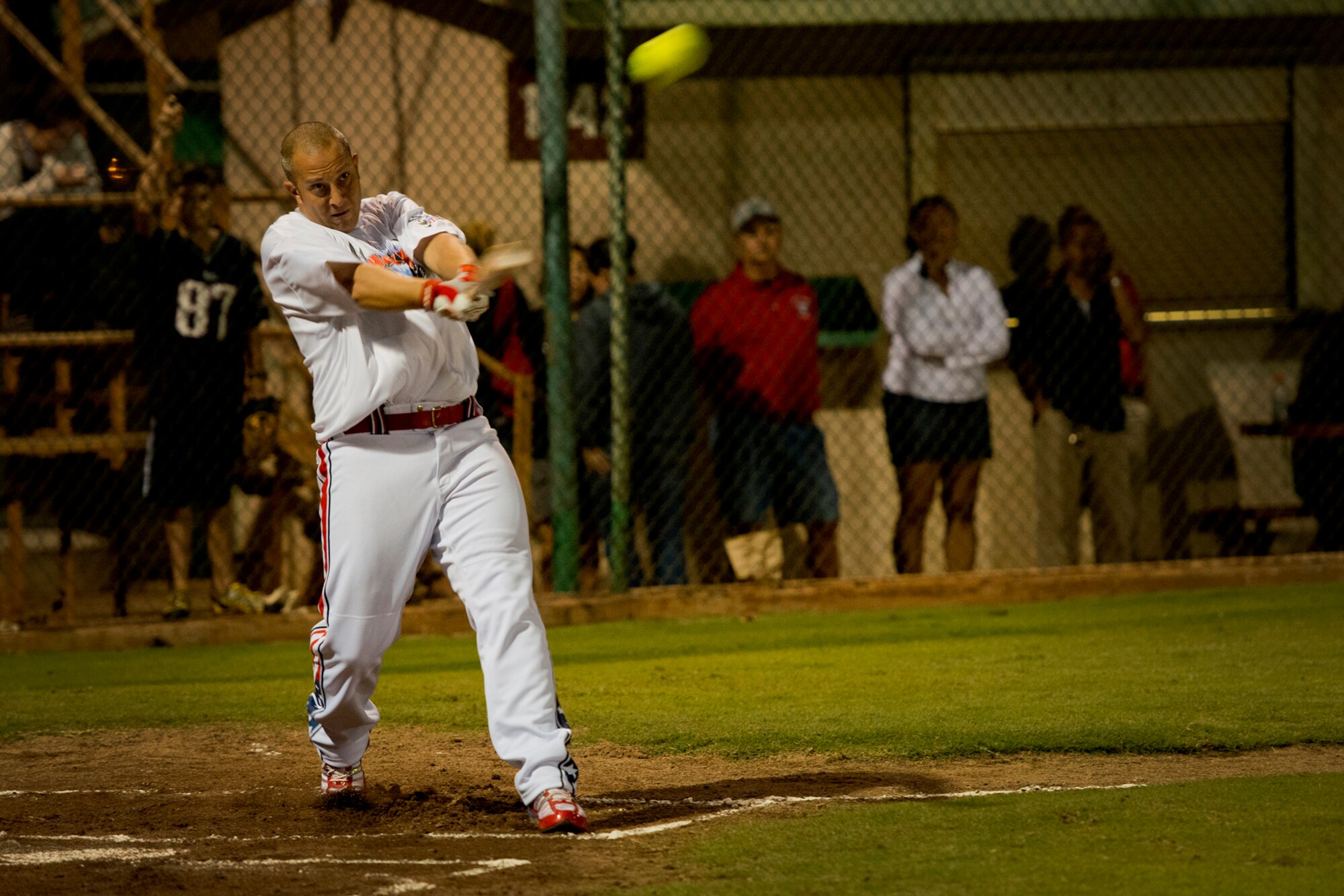 Jeremy Akerson, Hickam Force, connects with a pitch during the first game of a double header against the Wounded Warrior Amputee Softball Team Jan. 8, 2013, at Milican Field, Joint Base Pearl Harbor-Hickam, Hawaii. Hickam Force won the first game 18-1, but the Warriors held off the Chiefs Group to win 22-17. Akerson is a technical sergeant with the 747th Communications Squadron. The WWAST is comprised of competitive, athletic veterans and active duty servicemembers who have lost limbs during post-9/11 combat operations. The team includes individuals with a variety of amputations of the arm, above knee, below knee, bilateral below knee, and foot. Some are still in the service, while others are attending college thanks to the Post-9/11 GI Bill while others have moved on to new careers. (U.S. Air Force photo/Staff Sgt. Mike Meares)