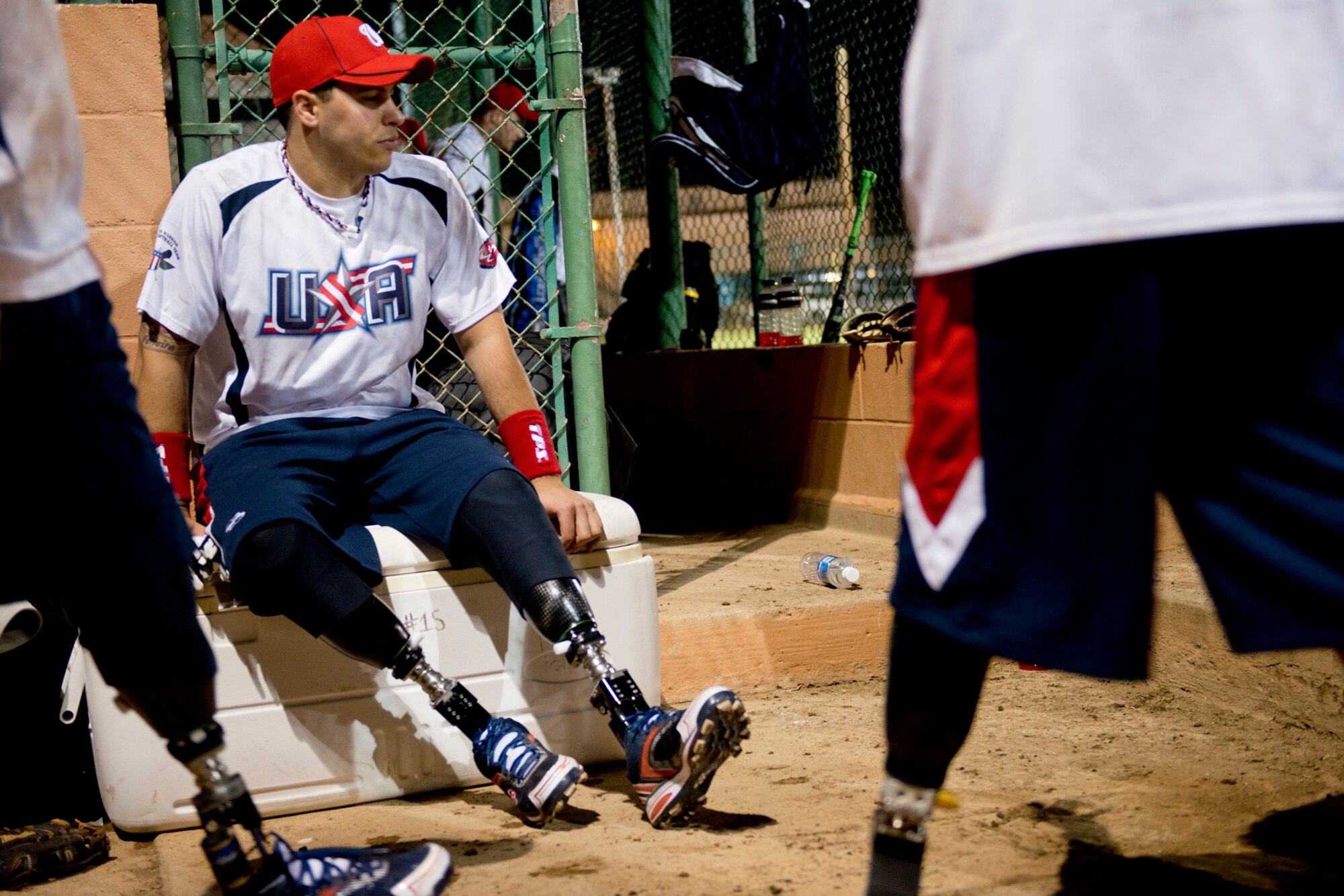 Matias Ferreira, Wounded Warrior Amputee Softball Team, takes a break between innings of the double-header softball game against Hickam Airmen, Jan. 8, 2013, at Milican Field, Joint Base Pearl Harbor-Hickam, Hawaii. An accurate scorecard helps the Warriors track their statistics throughout the season. The WWAST is comprised of competitive, athletic veterans and active duty servicemembers who have lost limbs during post-9/11 combat operations. The team includes individuals with a variety of amputations of the arm, above knee, below knee, bilateral below knee, and foot. Some are still in the service, while others are attending college thanks to the Post-9/11 GI Bill while others have moved on to new careers. (U.S. Air Force photo/Staff Sgt. Mike Meares)