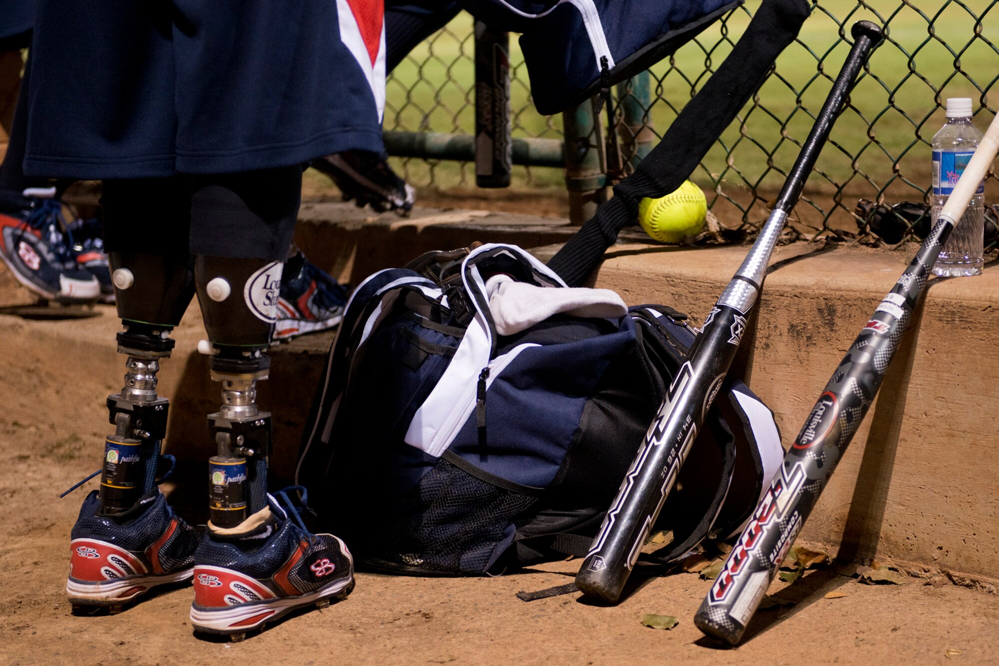 A member of the Wounded Warrior Amputee Softball Team waits to take the field, Jan. 8, 2013, at Milican Field, Joint Base Pearl Harbor-Hickam, Hawaii. During the double header, Hickam Force won the first game 18-1, but the Warriors held off the Chiefs Group to win 22-17. The WWAST is comprised of competitive, athletic veterans and active duty servicemembers who have lost limbs during post-9/11 combat operations. The team includes individuals with a variety of amputations of the arm, above knee, below knee, bilateral below knee, and foot. Some are still in the service, while others are attending college thanks to the Post-9/11 GI Bill while others have moved on to new careers. (U.S. Air Force photo/Staff Sgt. Mike Meares)