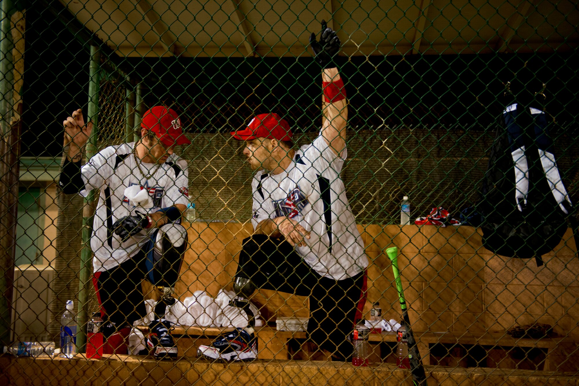 Nick Clark and Bobby McCardel, chat about their prosthetic limbs during a double header against the Hickam Airmen, Jan. 8, 2013, at Milican Field, Joint Base Pearl Harbor-Hickam, Hawaii. The Warriors beat the Chiefs 22-17. The WWAST is comprised of competitive, athletic veterans and active duty servicemembers who have lost limbs during post-9/11 combat operations. The team includes individuals with a variety of amputations of the arm, above knee, below knee, bilateral below knee, and foot. Some are still in the service, while others are attending college thanks to the Post-9/11 GI Bill while others have moved on to new careers. (U.S. Air Force photo/Staff Sgt. Mike Meares)