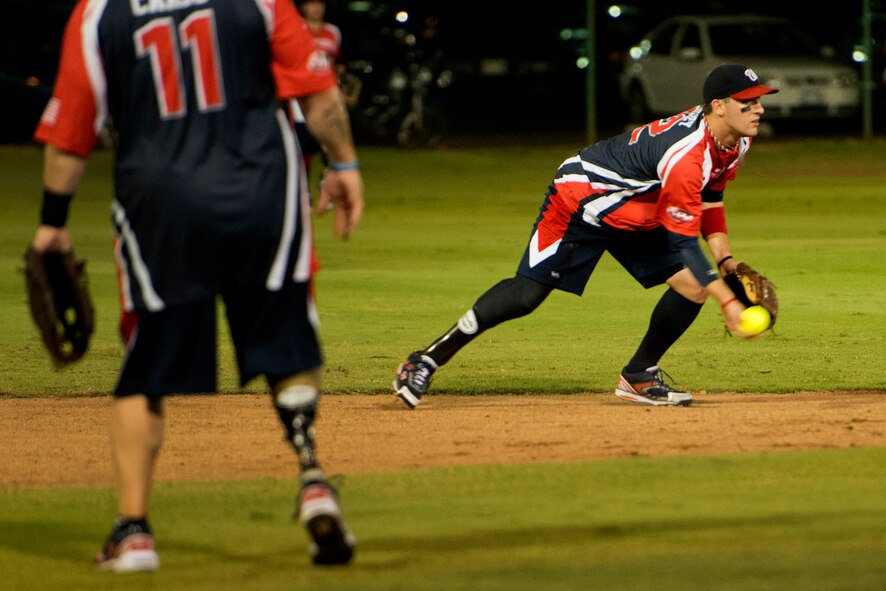Matt Kinsey, Wounded Warrior Amputee Softball Team, tosses a connects with a pitch during the first inning of play against the Hickam Force Jan. 8, 2013, at Milican Field, Joint Base Pearl Harbor-Hickam, Hawaii. Hickam Force won the first game 18-1, but the Warriors held off the Chiefs Group to win 22-17. The WWAST is comprised of competitive, athletic veterans and active duty servicemembers who have lost limbs during post-9/11 combat operations. The team includes individuals with a variety of amputations of the arm, above knee, below knee, bilateral below knee, and foot. Some are still in the service, while others are attending college thanks to the Post-9/11 GI Bill while others have moved on to new careers. (U.S. Air Force photo/Staff Sgt. Mike Meares)