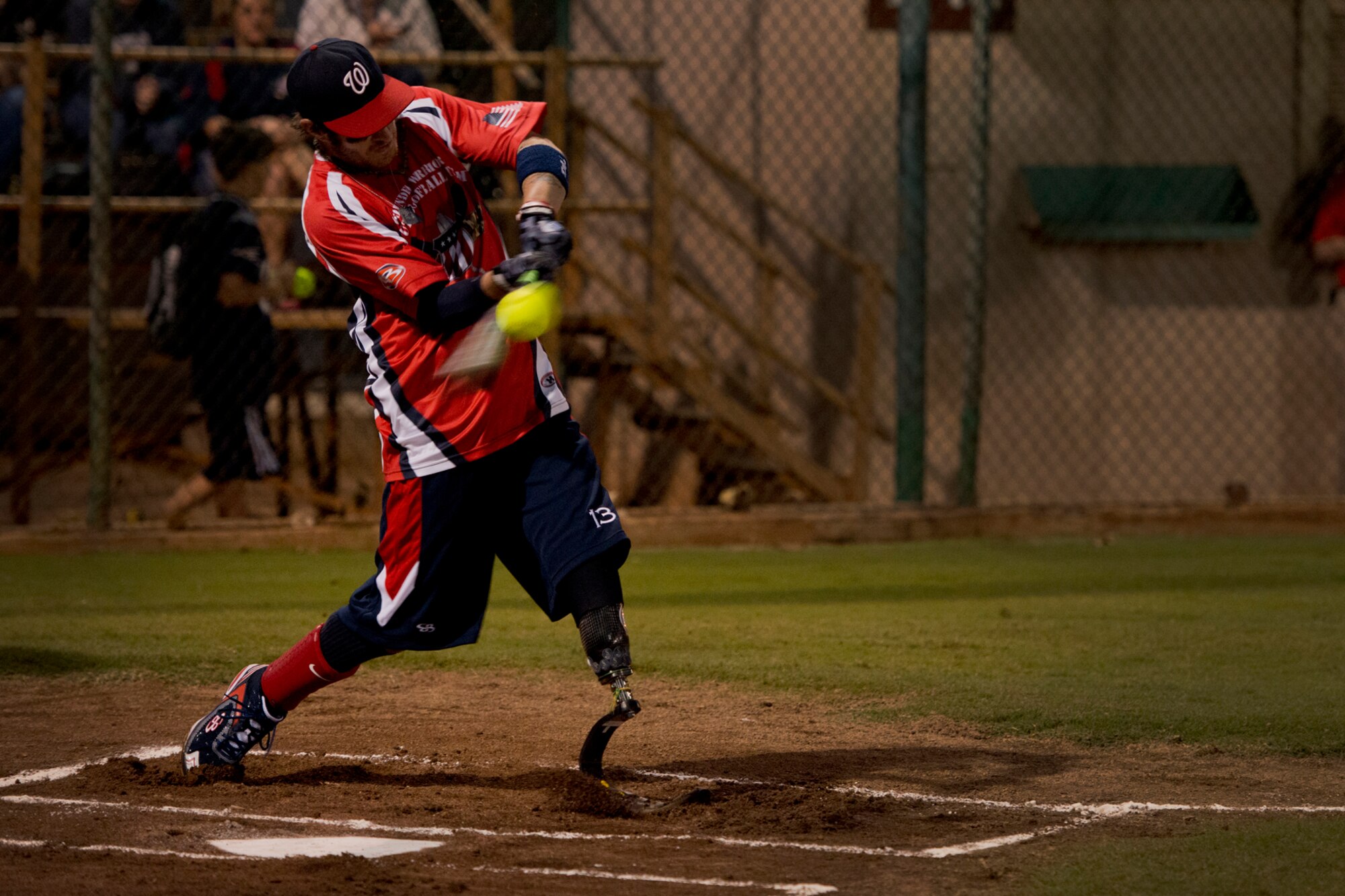 Nick Clark, Wounded Warrior Amputee Softball Team, connects with a pitch during the first inning of play against the Hickam Force Jan. 8, 2013, at Milican Field, Joint Base Pearl Harbor-Hickam, Hawaii. Hickam Force won the first game 18-1, but the Warriors held off the Chiefs Group to win 22-17.  The WWAST is comprised of competitive, athletic veterans and active duty servicemembers who have lost limbs during post-9/11 combat operations. The team includes individuals with a variety of amputations of the arm, above knee, below knee, bilateral below knee, and foot. Some are still in the service, while others are attending college thanks to the Post-9/11 GI Bill while others have moved on to new careers. (U.S. Air Force photo/Staff Sgt. Mike Meares)