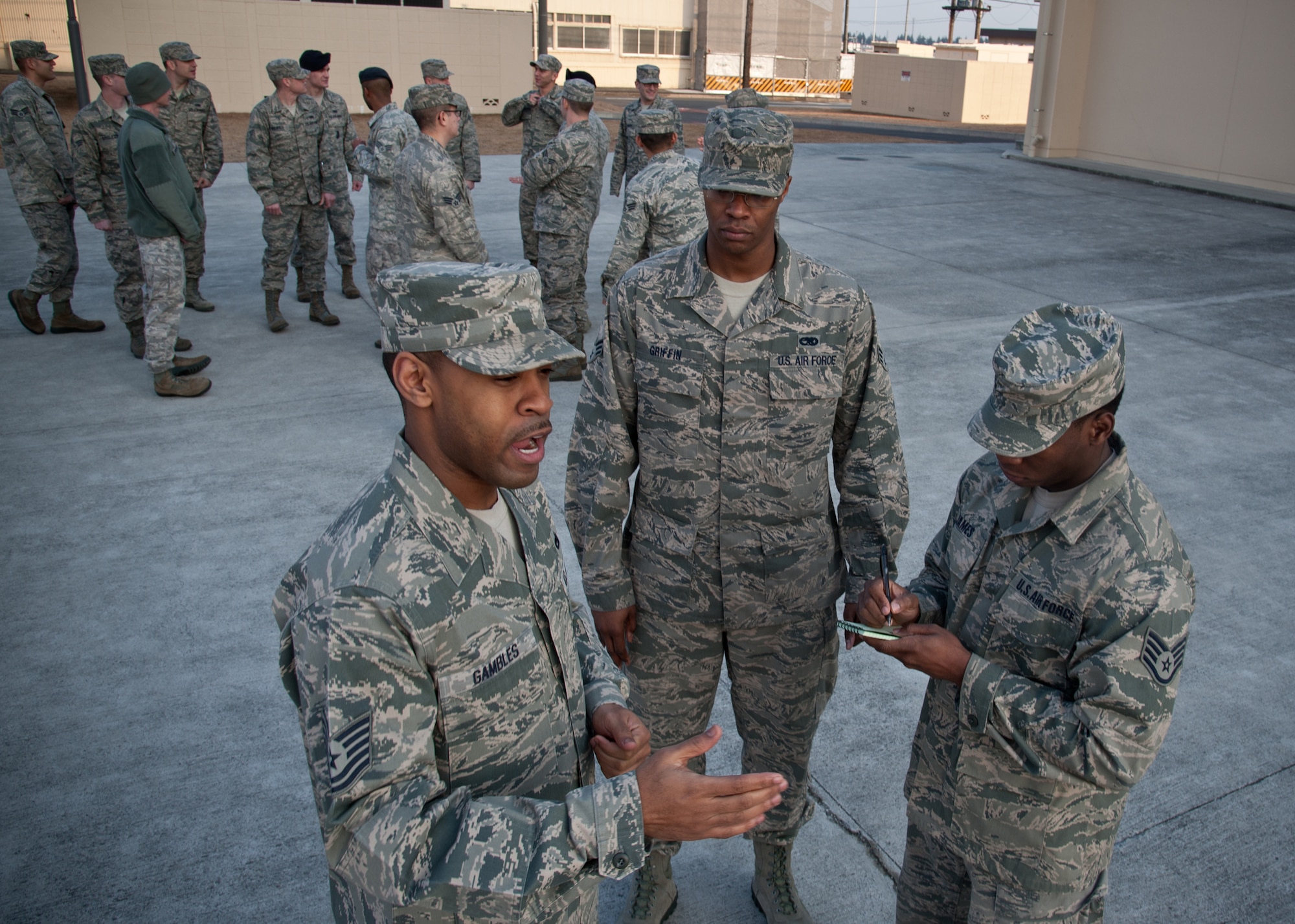 YOKOTA AIR BASE, Japan -- Tech. Sgt. Joseph Gambles, 374th Force Support Squadron Airman Leadership School instructor, describes commands for falling in and out of formation to a student Jan. 9, 2013, at the Yokota Professional Development Center. Gambles has instructed seven ALS classes since becoming a professional military education instructor. (U.S. Air Force photo by Senior Airman Cody H. Ramirez)
