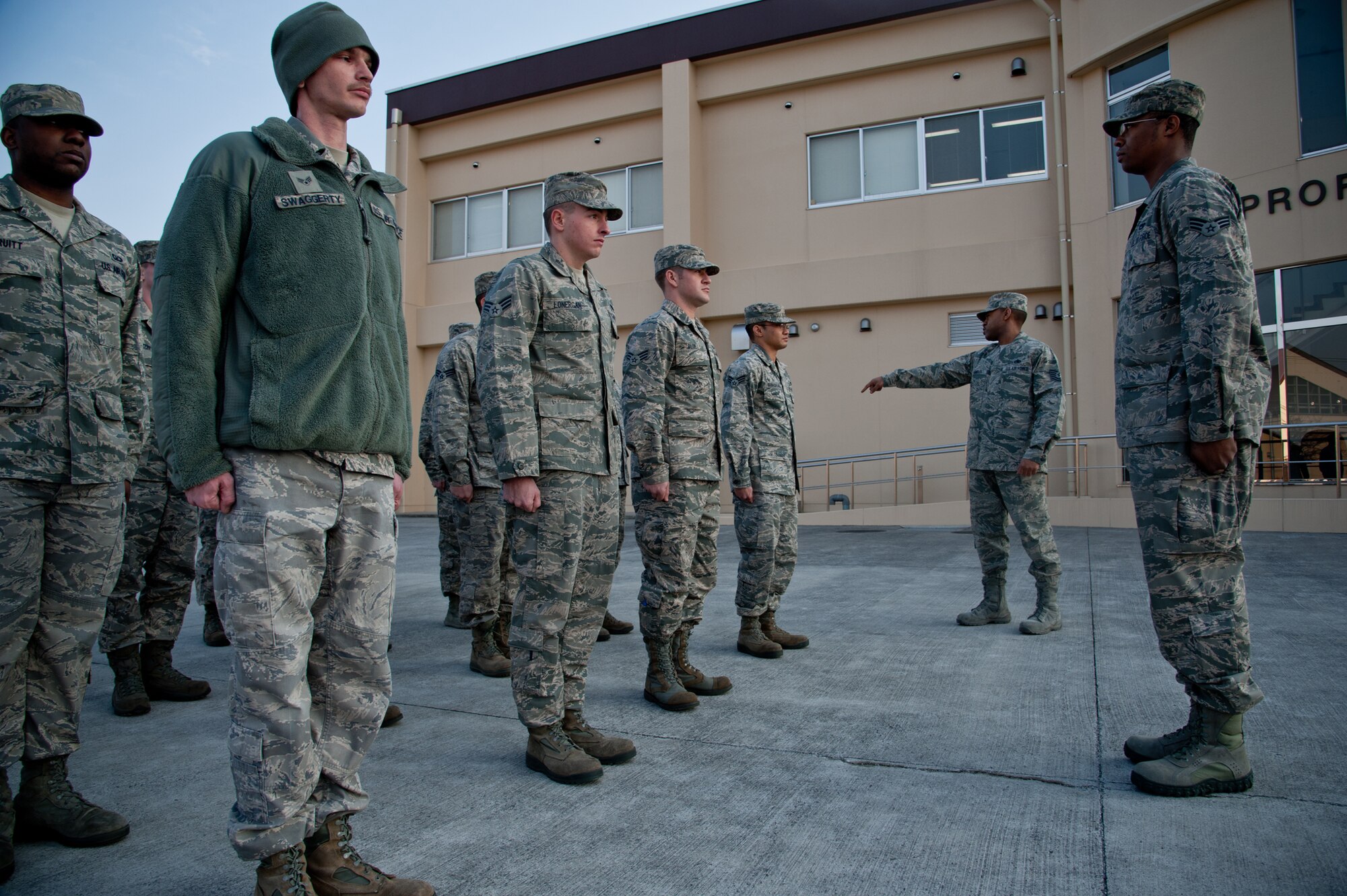 YOKOTA AIR BASE, Japan -- Tech. Sgt. Joseph Gambles (Center right), 374th Force Support Squadron Airman Leadership School instructor, directs a student on commanding a four-element flight Jan. 9, 2013, during a class at the Yokota Professional Development Center. Students reviewed formation commands to organize each individual by height and to maintain proper distance from each other. (U.S. Airforce photo by Senior Airman Cody H. Ramirez) 