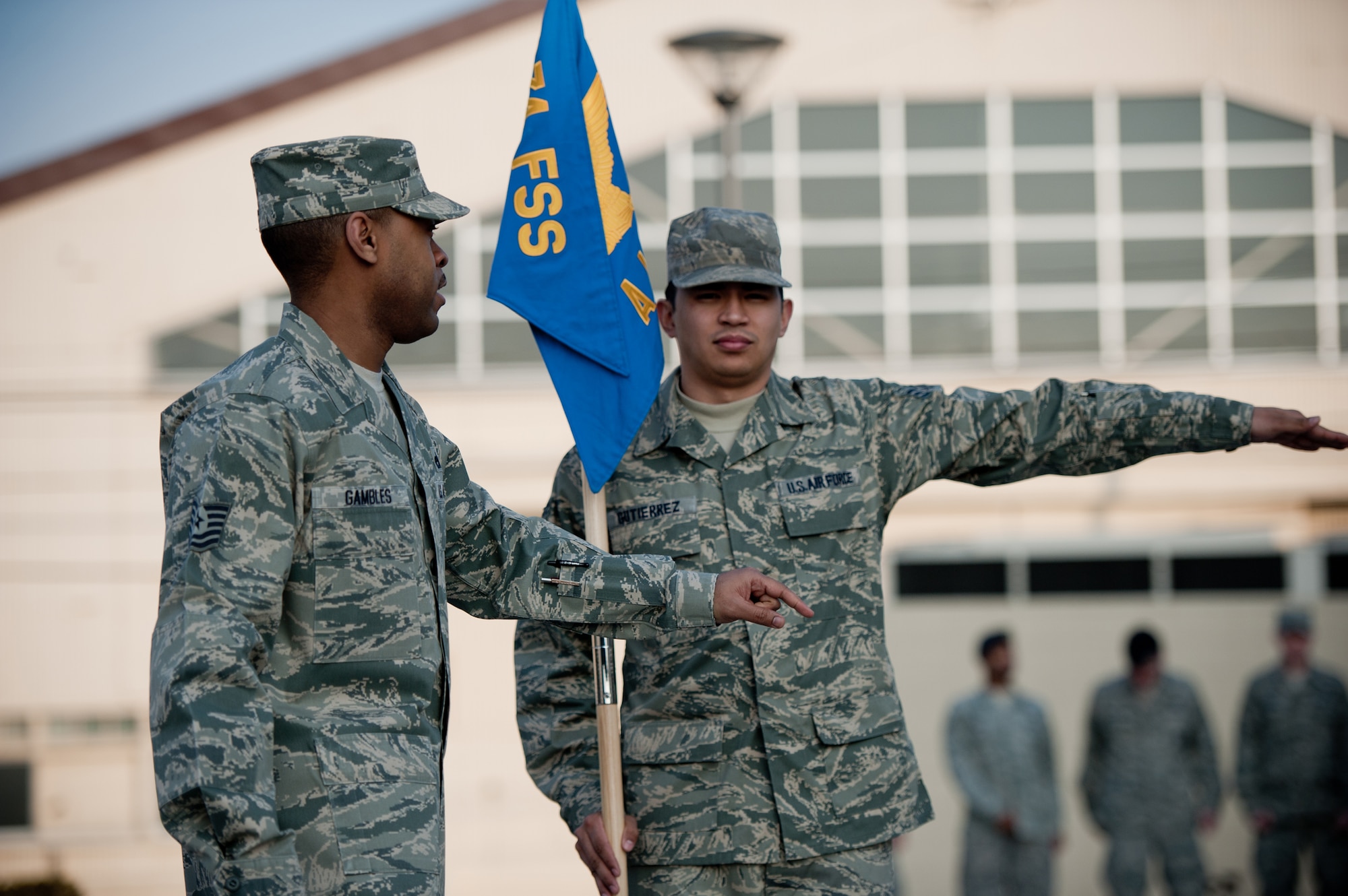YOKOTA AIR BASE, Japan -- Tech. Sgt. Joseph Gambles, 374th Force Support Squadron Airman Leadership School instructor, provides drill instruction to Senior Airman Kevin Gutierrez, 374th Logistical Readiness Squadron, during class Jan. 9, 2013, at the Yokota Professional Development Center.  Gambles asked for a student who had no prior guidon bearing experience, and Gutierrez stepped up to the challenge. (U.S. Air Force photo by Senior Airman Cody H. Ramirez)