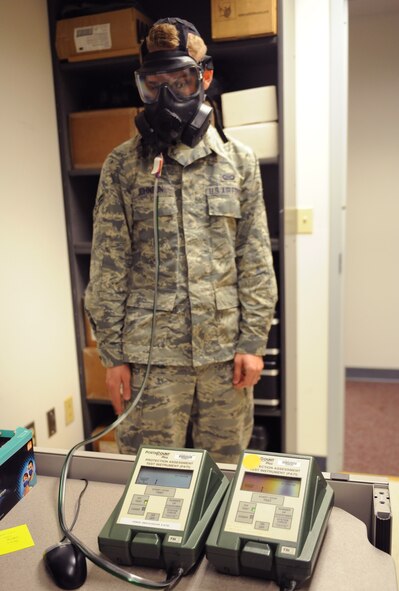 A Photocount Plus machine displays data as Airman 1st Class Brandon Johnson, 608th Air Operations Center operations intelligence analyst, receives a gas mask fit test on Barksdale Air Force Base, La., Jan. 10. The machine takes particle readings from the air in the room and compares it to the air found in the gas masks to ensure the masks are sealed properly. (U.S. Air Force photo/Airman 1st Class Benjamin Gonsier)