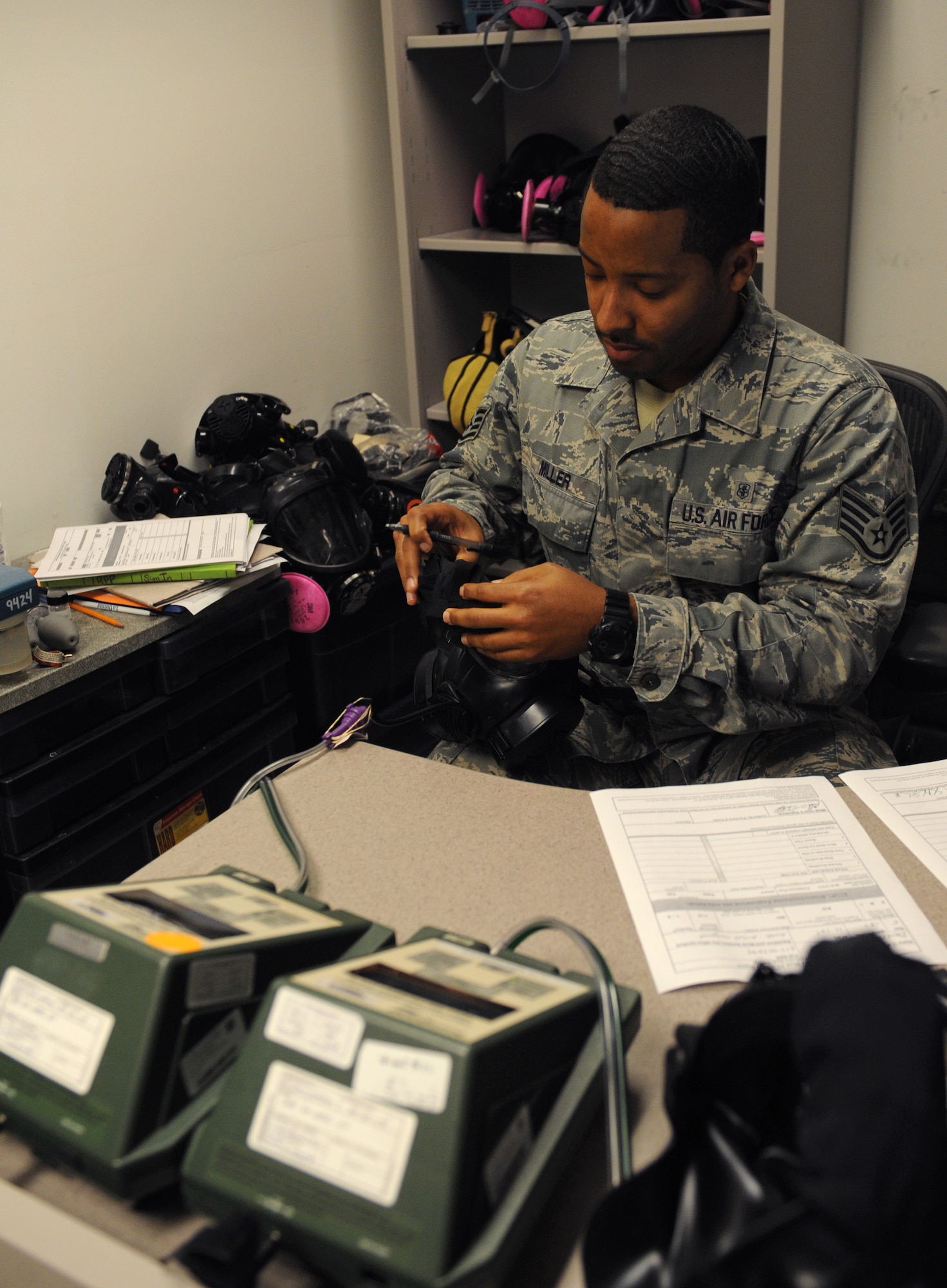 Staff Sgt. Robert D. Miller, 2nd Aerospace Medicine Squadron, adjusts the straps of an M-50 gas mask during a gas mask fit test on Barksdale Air Force Base, La., Jan. 10. Gas mask fit tests, which are held every Thursday from 8 a.m. to 11 a.m. at Bio-Environmental Engineering, ensure Barksdale Airmen have the correctly sized gas mask that can protect them from chemical and biological warfare agents. (U.S. Air Force photo/Airman 1st Class Benjamin Gonsier)
