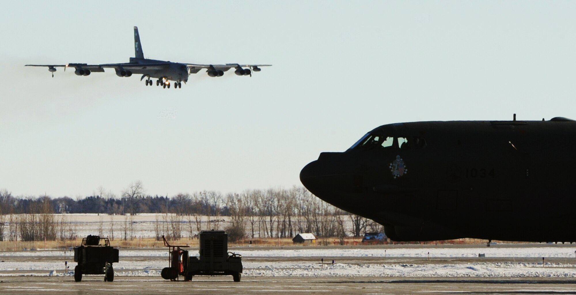 MINOT AIR FORCE BASE, N.D. -- Col. James Dawkins Jr., 5th Bomb Wing commander, lands a B-52H Stratofortess during his “fini-flight” here Jan. 7. The “fini-flight” is the final flight taken by an aircrew member at their current assignment. It is Air Force tradition to have family, friends and Airmen from the wing, toast the departing aircrew member and hose them down with water as they debark the aircraft. (U.S. Air Force photo/Senior Airman Brittany Y. Auld)