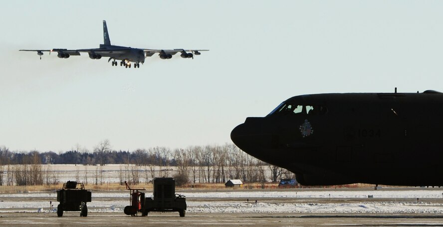 MINOT AIR FORCE BASE, N.D. -- Col. James Dawkins Jr., 5th Bomb Wing commander, lands a B-52H Stratofortess during his “fini-flight” here Jan. 7. The “fini-flight” is the final flight taken by an aircrew member at their current assignment. It is Air Force tradition to have family, friends and Airmen from the wing, toast the departing aircrew member and hose them down with water as they debark the aircraft. (U.S. Air Force photo/Senior Airman Brittany Y. Auld)