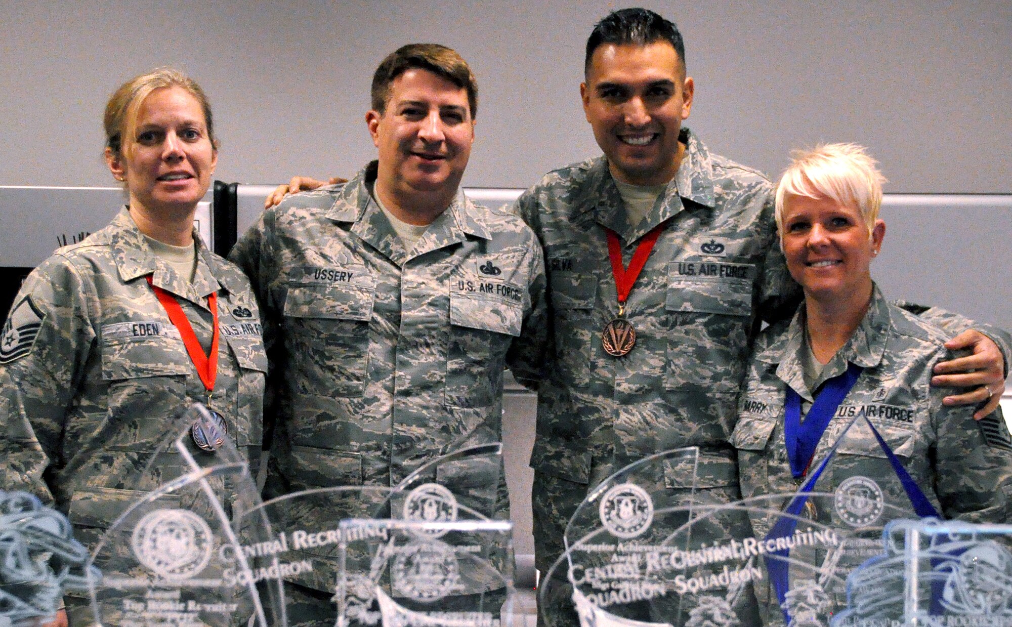 From left, Master Sgt. Sherri Eden, Chief Master Sgt. Randall Ussery, Tech. Sgt. Gabriel Silva and Tech. Sgt. Tracey Barry show off the medals and awards they won for their recruiting efforts in 2012. These four make up part of the team responsible for Air Force Reserve recruiting in Colorado. The team was honored as a Top Operation location at the 2012 Air Force Reserve Command Recruiting awards banquet. (U.S. Air Force photo/Tech. Sgt. Daniel Butterfield)