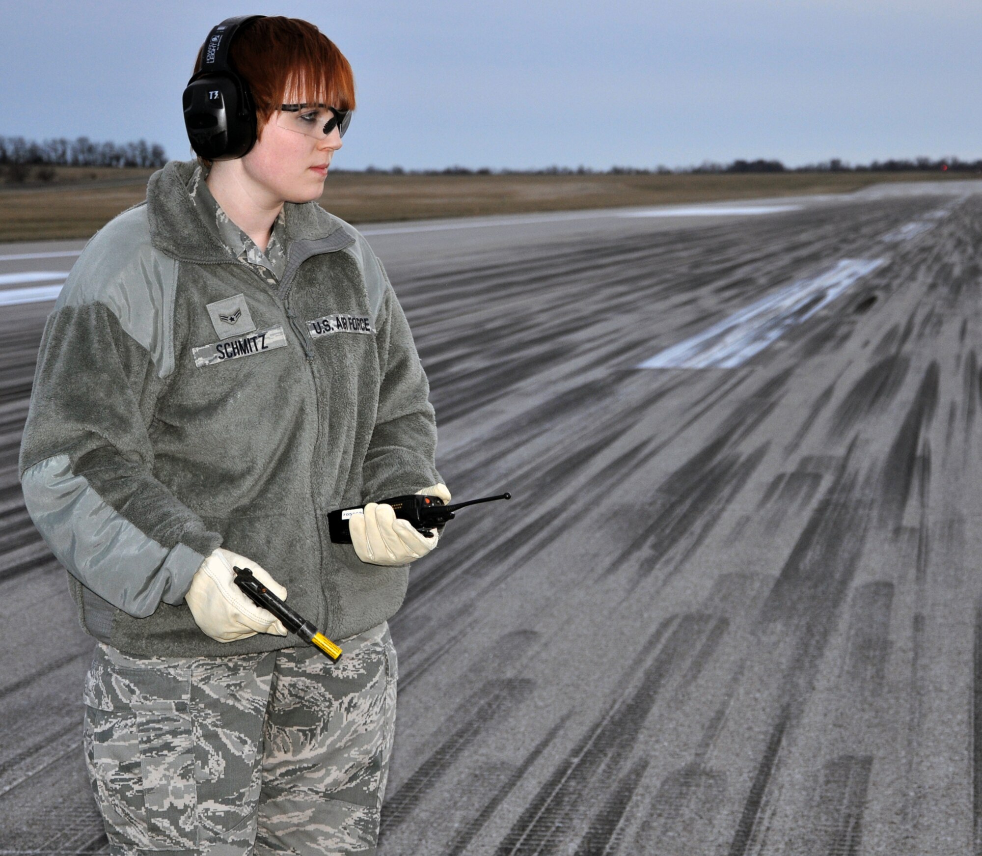 Airman 1st Class Hannah A. Schmitz, 509th Operations Support Squadron airfield managment shift lead, prepares to fire a flare to scare off birds near the runway here, Jan. 9, 2013. The flares are part of the bird airfield strike hazard program, which was instituted to deter bird-strikes on base aircraft. The 509th OSS is part of the 509th Bomb Wing, an Air Force Global Strike Command active duty unit here. (U.S. Air Force Photo by Senior Airman Wesley Wright/Released)