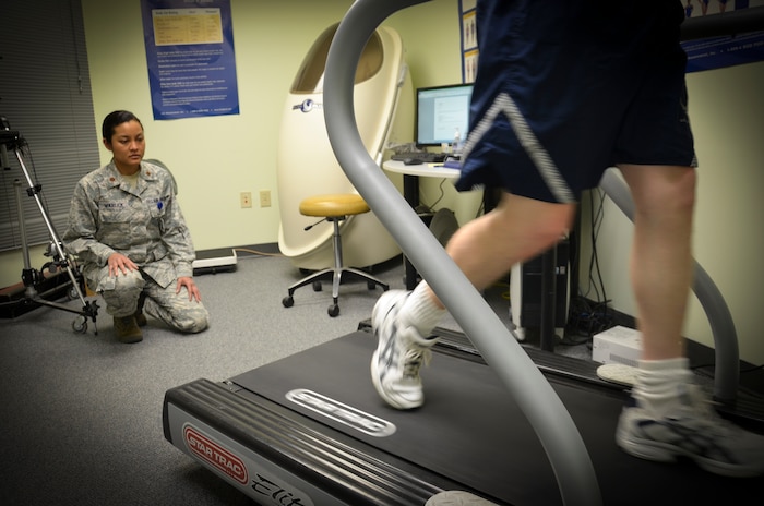 (Right) Maj. Lee Warlick, 628th Medical Operations Squadron Physical Therapy flight commander, observes an Airman walk on a treadmill during a Gait Analysis Clinic appointment, Jan. 8, 2013 at Joint Base Charleston – Air Base, S.C. During a session with the Gait Analysis Clinic, a physical therapist will observe a patient walk on a treadmill with running shoes and bare-foot. (U.S. Air Force photo/Staff Sgt. Anthony Hyatt)