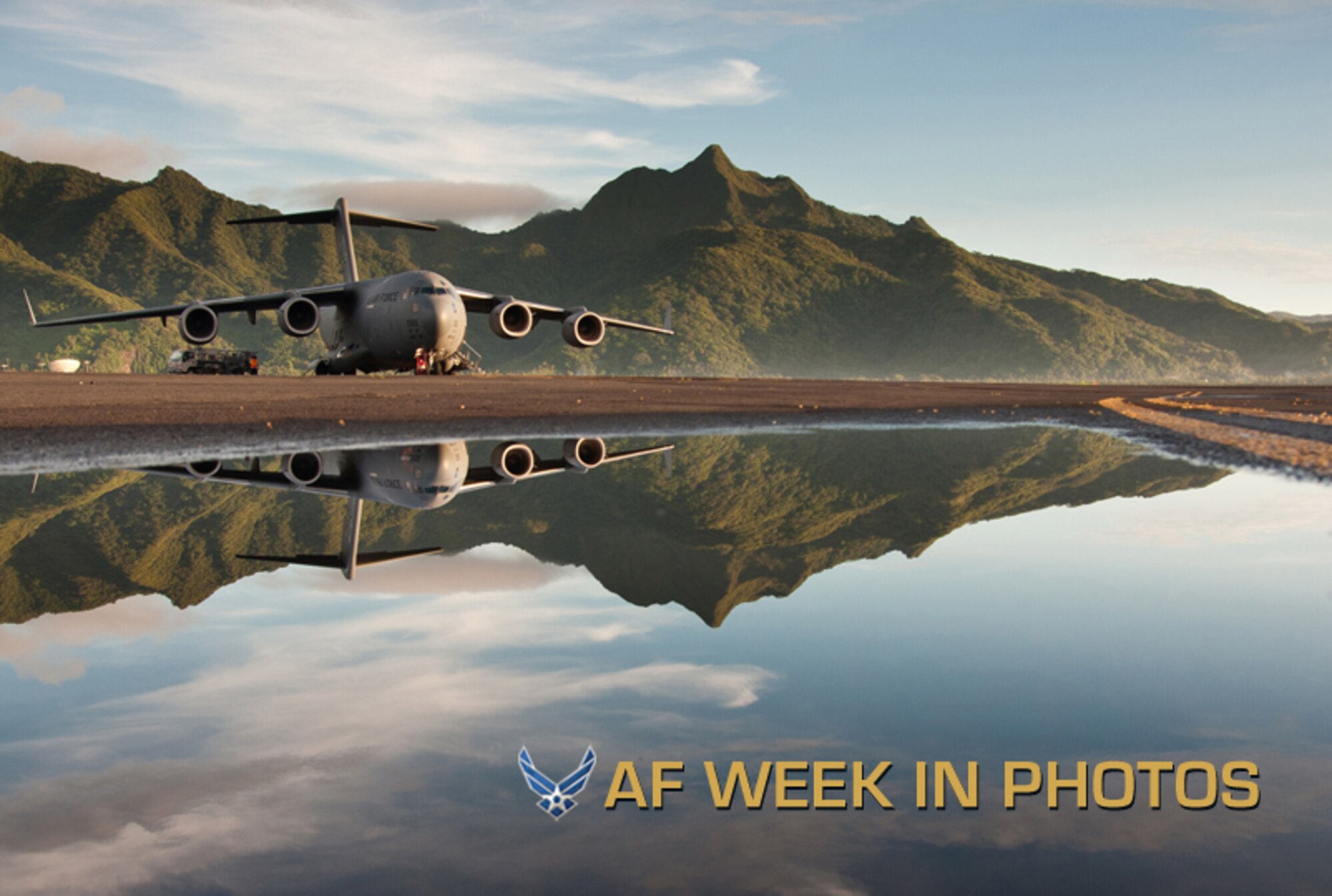 A C-17 Globemaster III sits on the runway at Pago Pago International Airport in American Samoa, Dec. 16, 2012. The 446th Airlift Wing aircrew from Joint Base Lewis-McChord, Wash., traveled to Royal Australian Air Force Base Richmond, Australia, in support of a joint operation. Tropical Cyclone Evan passed over American Samoa Dec. 12 -16 causing 6,000 people to take shelter in evacuation centers and $4.1 million in damages to infrastructure. The puddle in the foreground is a result of the rains from that storm system. (U.S. Air Force photo/Staff Sgt. Jon Polka)
