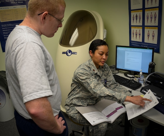 (Right) Maj. Lee Warlick, 628th Medical Operations Squadron Physical Therapy flight commander, briefs Staff Sgt. Christopher Hammond, 437th Aircraft Maintenance Squadron crew chief, on tips to buy better running shoes during an appointment at the Gait Analysis Clinic, Jan. 8, 2013 at Joint Base Charleston – Air Base, S.C. The clinic helps prevent injuries and improve performance in running. (U.S. Air Force photo/Staff Sgt. Anthony Hyatt)