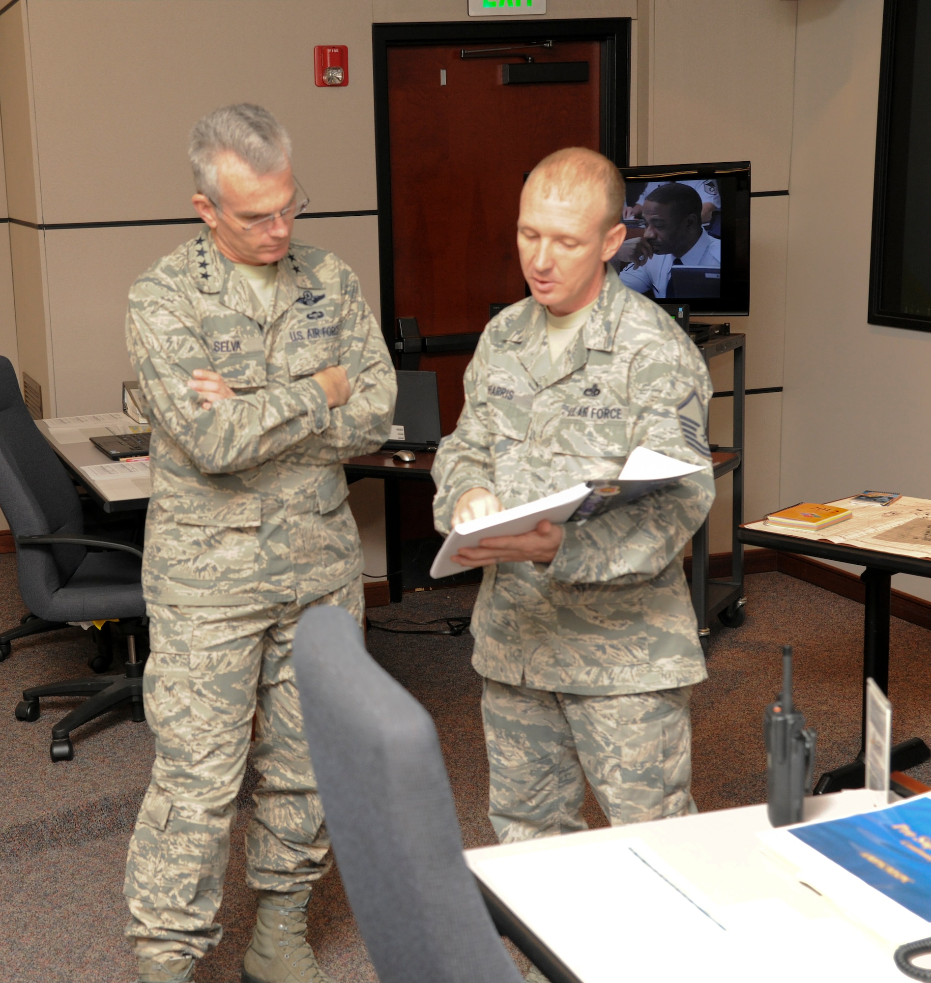 Master Sgt. James Harris, Mobility Operations School, shows Gen. Paul Selva, Air Mobility Command commander, a training aid for the Aircraft Maintenance Production superintendent course at the U.S. Air Force Expeditionary Center Jan. 9 at Joint Base McGuire-Dix-Lakehurst, N.J. (U.S. Air Force photo by Tech. Sgt. Zachary Wilson/Released.)