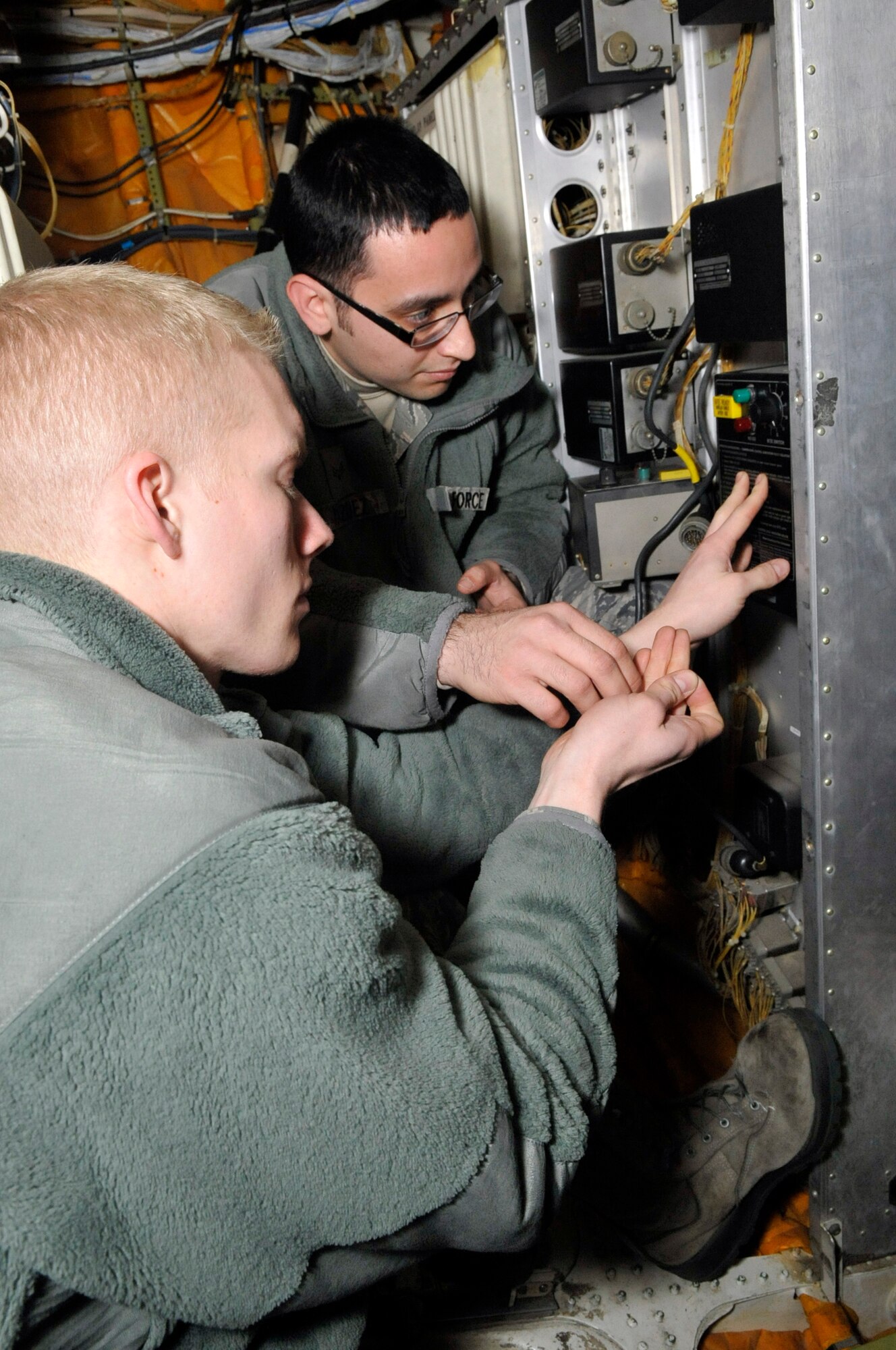 Airman 1st Class Brandon Jones and Senior Airman Juan Velazquez, 605th Aircraft Maintenance Squadron electrician and environment specialists, change an Auxiliary Power Unit Pack Temperature Demand Controller on a KC-10 Extender that has fluxuating frequencies Dec. 27, 2012, on Joint Base McGuire-Dix-Lakehurst, N.J. The 605th AMXS comprises more than 400 active-duty and Reserve Airmen who maintain 32 KC-10 aircraft. The squadron is known around the world for ‘bringing fuel to the fight.’ Velazquez and Jones hail from Phoenix and Centerville, Ind. (U.S. Air Force photo by Wayne Russell/Released)