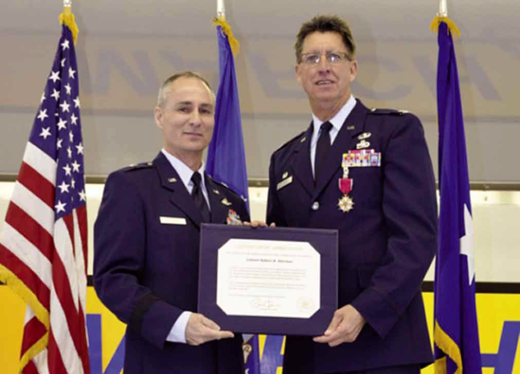 Col. Stormes (right), commander, 452d Maintenance Group, March Air Reserve Base, Calif., retired after more than 30 years of dedicated military service, Jan. 5, at a ceremony held in Bldg. 2306. He oversaw the operation of four squadrons that employ more than 1,000 reserve, active duty, DOD civilian and contractor personnel. Brig. Gen. Karl McGregor, deputy director, Air Force Strategic Planning, Headquarters Air Force, Pentagon, Washington, D.C. had the honor of presenting Col. Stormes with his retirement certificate and medal. (U.S. Air Force photo by Staff Sgt. Joe Davidson)