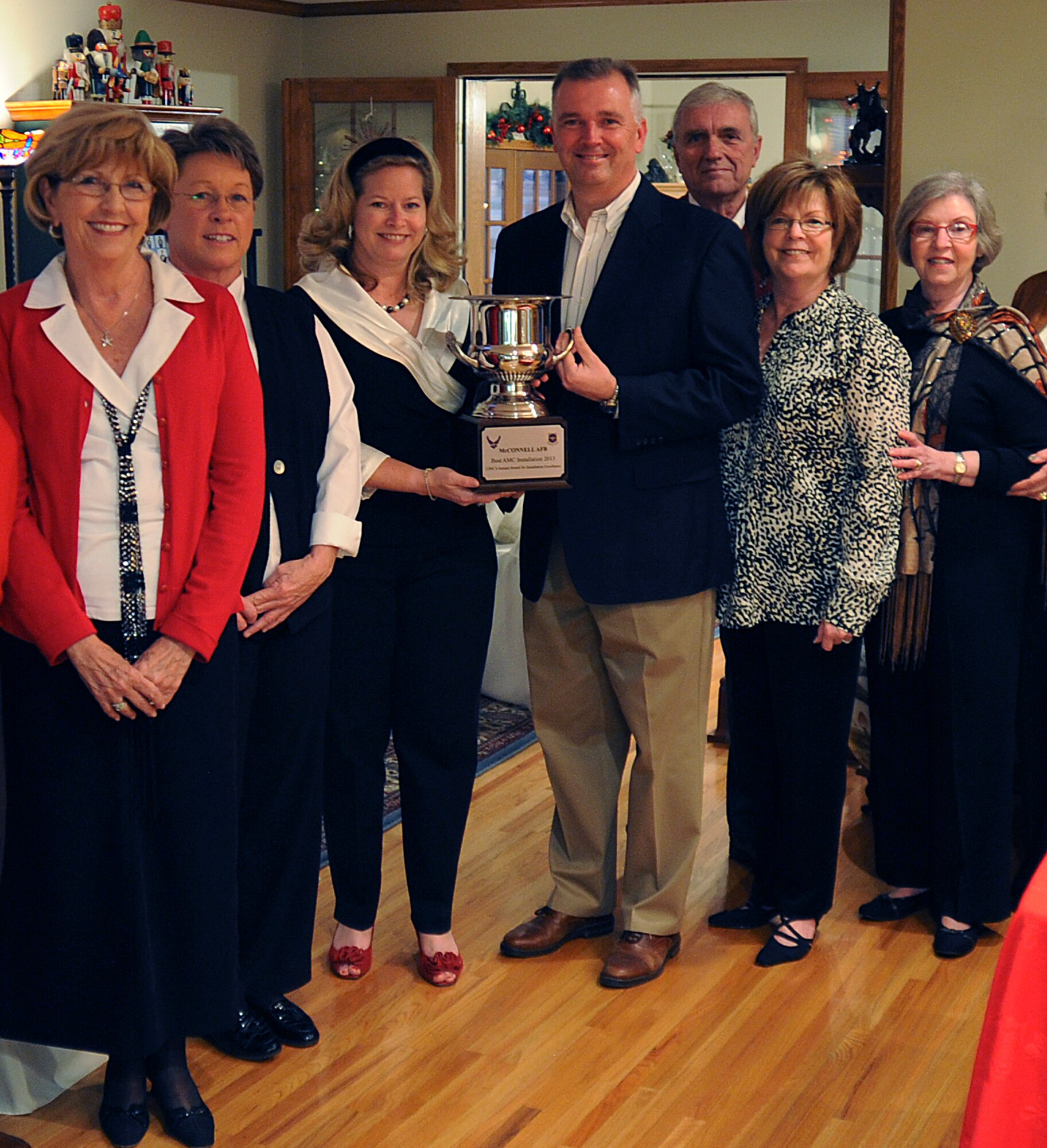 (Center) Col. Ricky Rupp, 22nd Air Refueling Wing commander, and spouse Charlotte, stand with the Air Mobility Command Installation Excellence Award trophy, Dec. 12, 2012, McConnell Air Force Base, Kan. AMC Recently nominated the Rupps for the 2013 General Jerome F. O'Malley and Diane O'Malley award. The annual award recognizes the wing commander and spouse team whose contributions to the nation, Air Force and local community best exemplify the highest ideals and positive leadership of a military couple in a key Air Force position. (U.S. Air Force photo/ Airman 1st Class Jose L. Leon) 

