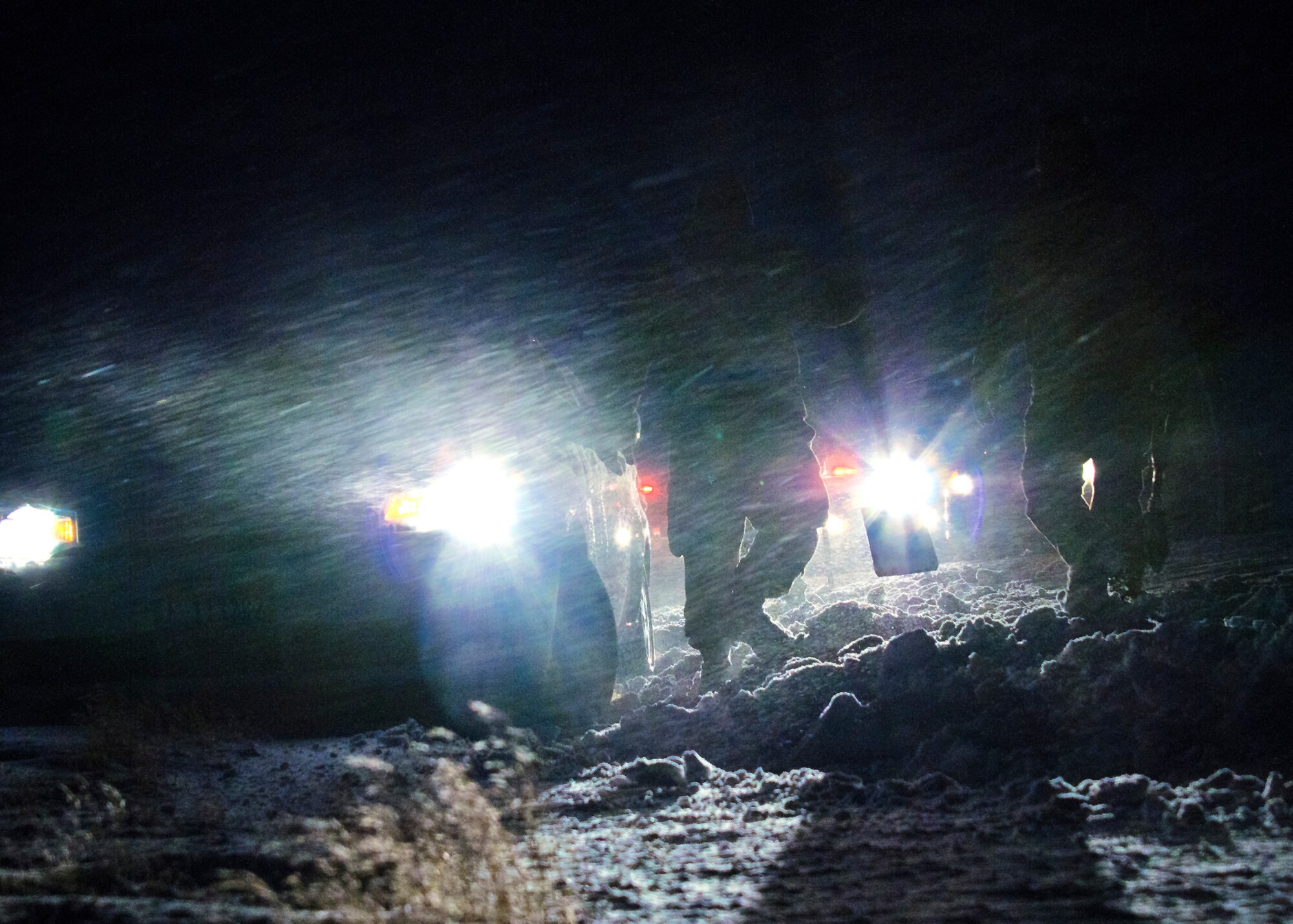 Tech. Sgt. Barry Williams, 366th Security Forces Squadron, and three other servicemembers, assist a stranded driver just outside the Mountain Home Air Force Base main gate, Jan. 10, 2013. According to Williams, Defenders can render first aid or respond to other emergency situations if dispatched. (U.S. Air Force photo/Master Sgt. Kevin Wallace/RELEASED)