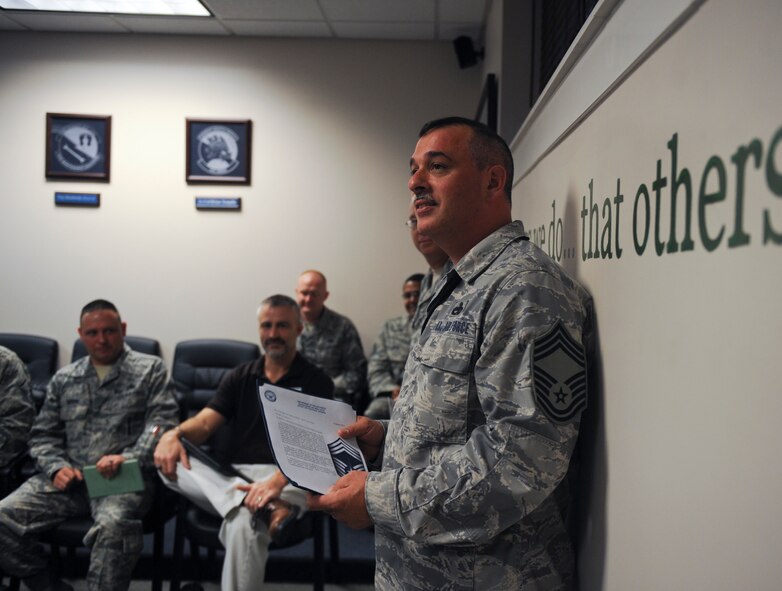 Newly promoted U.S. Air Force Chief Master Sgt. Roy Clayton, 75th Aircraft Maintenance Unit superintendent, thanks everyone for their support after a surprise promotion at Moody Air Force Base, Ga., Jan. 10, 2012. Only one percent of the enlisted force can obtain the rank of chief master sergeant. (U.S. Air Force photo by Airman 1st Class Olivia Bumpers/Released)