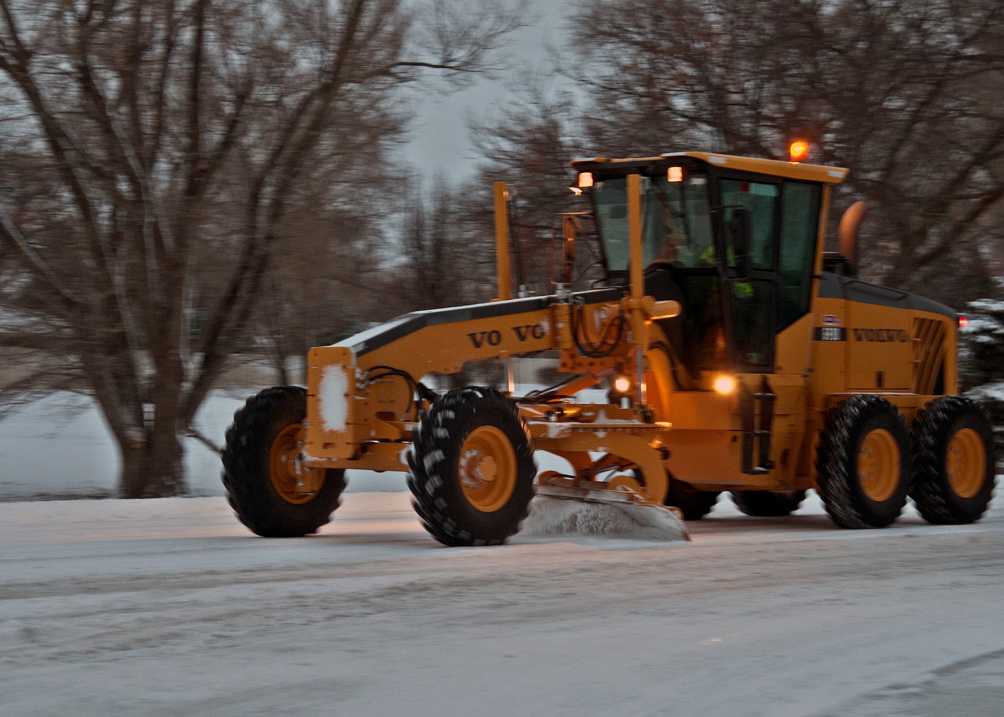 366th Civil Engineer Squadron personnel work to clear roads at Mountain Home Air Force Base Jan 10, 2013, after Storm Gandalf blanketed the base with a winter storm. An ongoing readiness exercise was paused temporarily due to the storm. (U.S. Air Force photo/Master Sgt. Kevin Wallace/RELEASED)