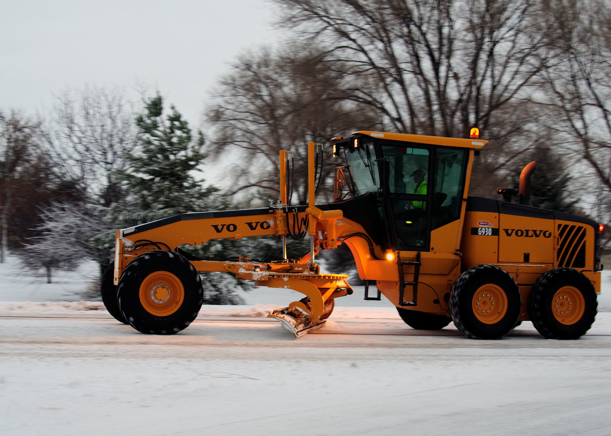 366th Civil Engineer Squadron personnel work to clear roads at Mountain Home Air Force Base Jan 10, 2013, after Storm Gandalf blanketed the base with a winter storm. An ongoing readiness exercise was paused temporarily due to the storm. (U.S. Air Force photo/Master Sgt. Kevin Wallace/RELEASED)