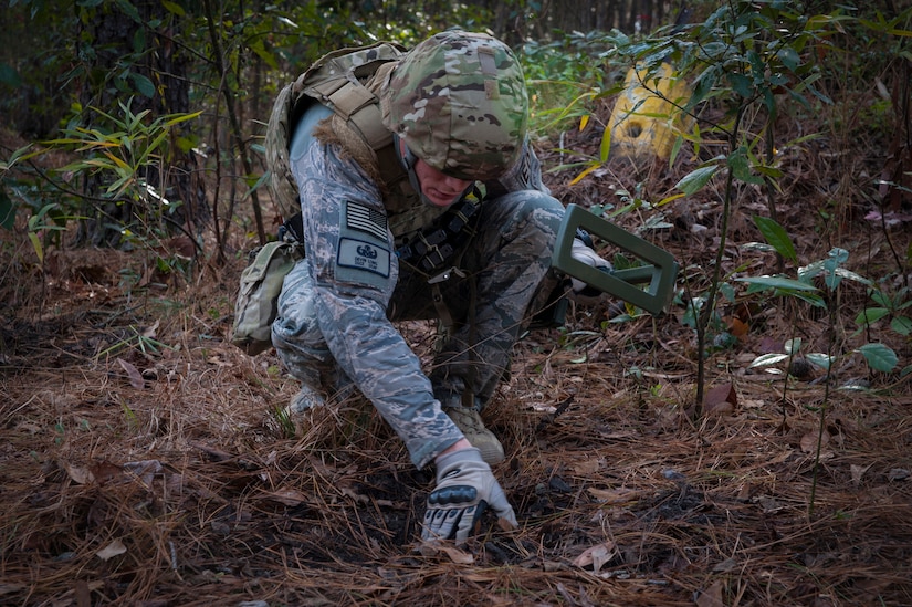 Staff Sgt. Devin Long, 628th Civil Engineer Squadron explosive ordnance disposal technician, searches for a wire used to detonate an improvised explosive device during a routine training exercise Jan. 8, 2013 at Joint Base Charleston - Air Base, S.C. The training prepares EOD members for the tasks involved with finding explosive devices in remote areas during deployments. (U.S. Air Force photo/Airman 1st Class Ashlee Galloway)